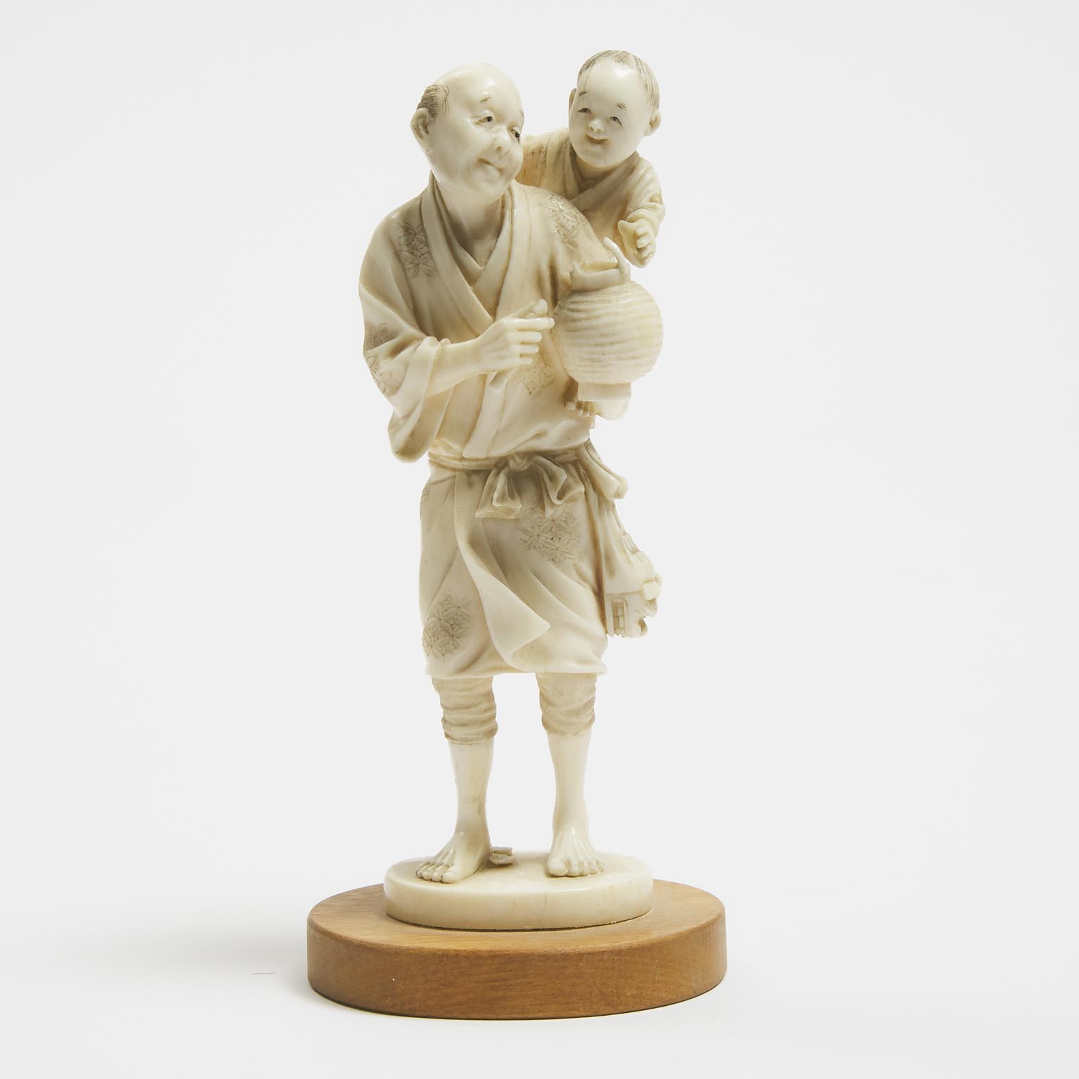 A Japanese Ivory Okimono of a Man and Child, Meiji Period