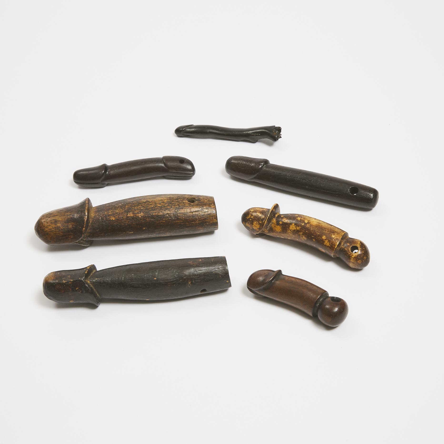 A Group of Seven Wooden Phalluses