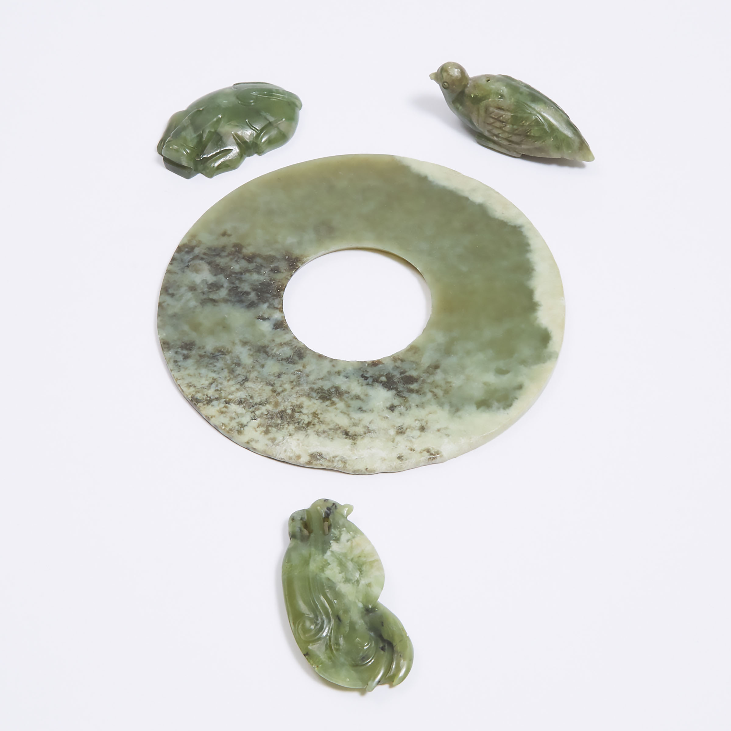 A Green Hardstone Bi Disc, Together With Three Carvings, 19th Century and Later