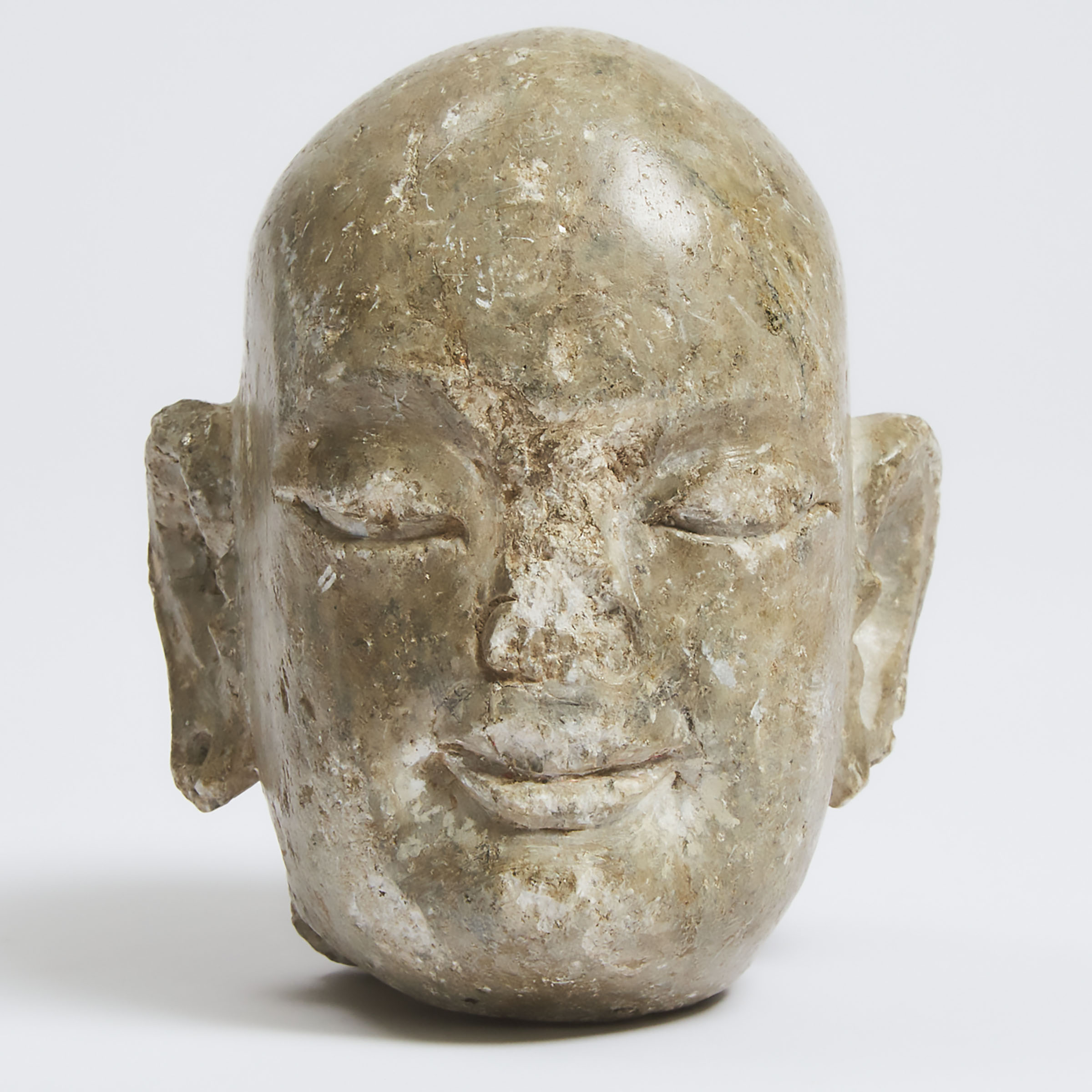 A Tang-Style Carved Limestone Head of a Monk