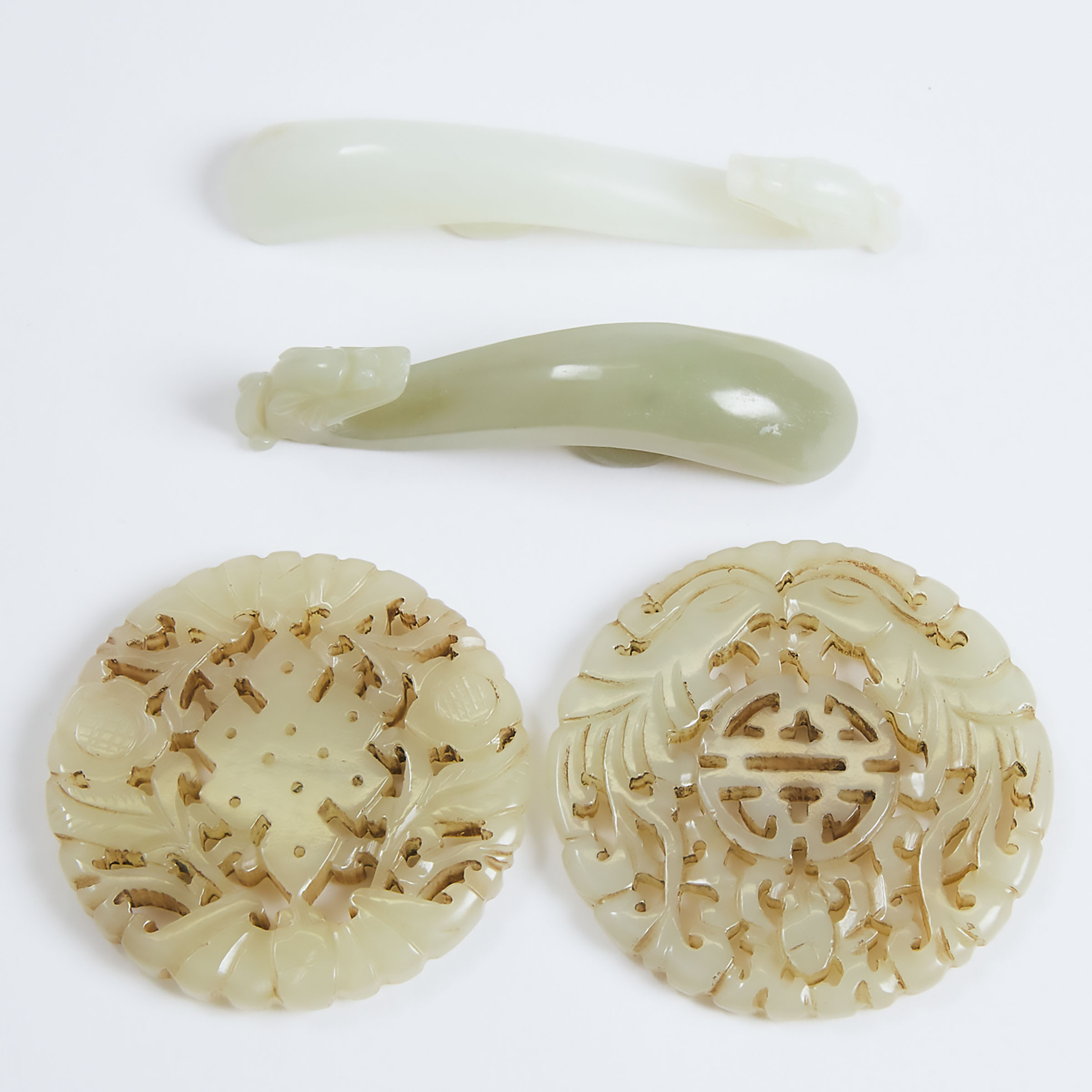 A Group of Four White and Celadon Jade Carvings