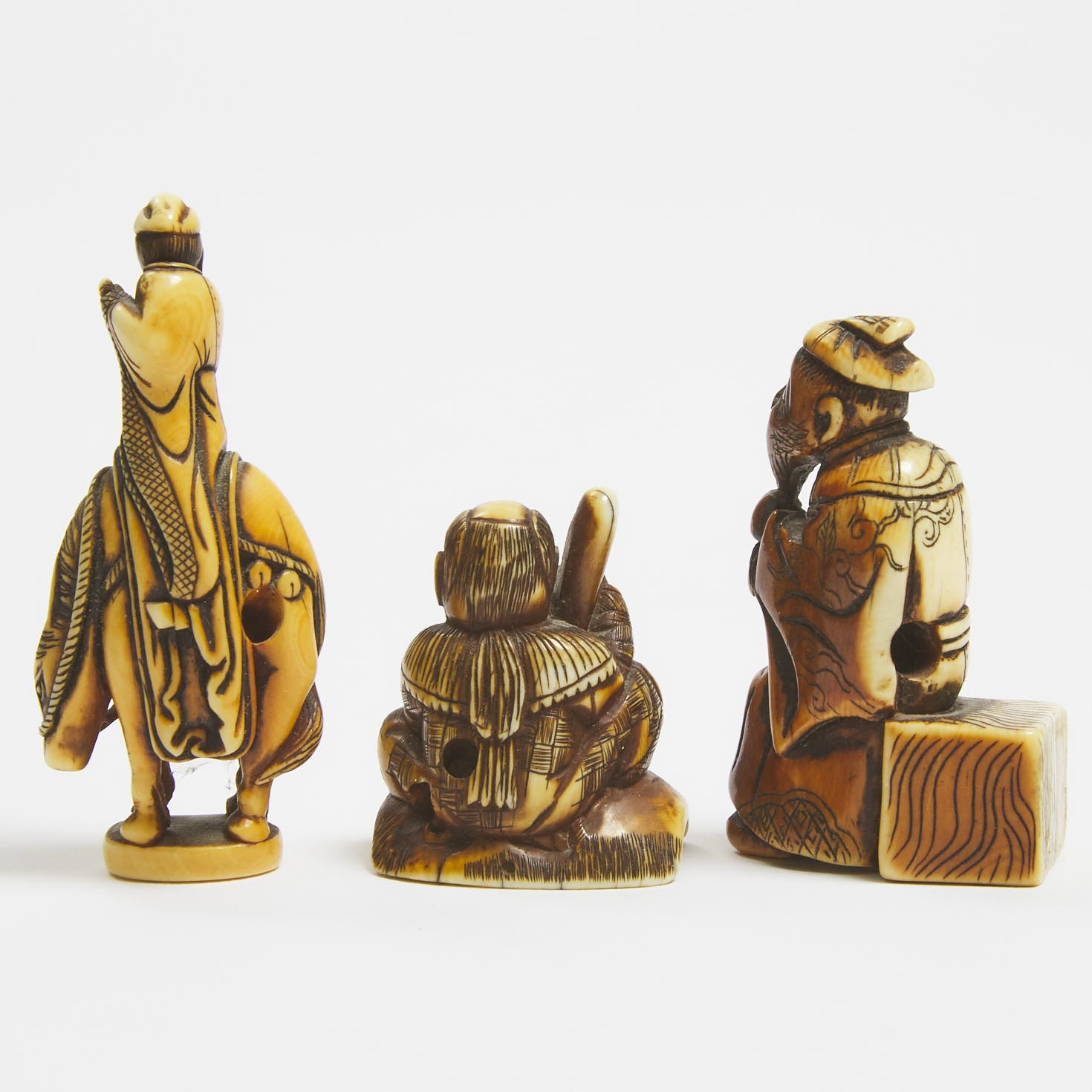 Three Ivory Netsuke Figures of Chokaro Sennin, a Karako Holding a Tengu Mask, and a Seated Immortal, Edo Period, 18th/19th Century