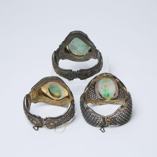 Three Chinese Silver Filigree 'Longevity' Bangles Inset with Carved Jadeite, Qing Dynasty, 19th Century