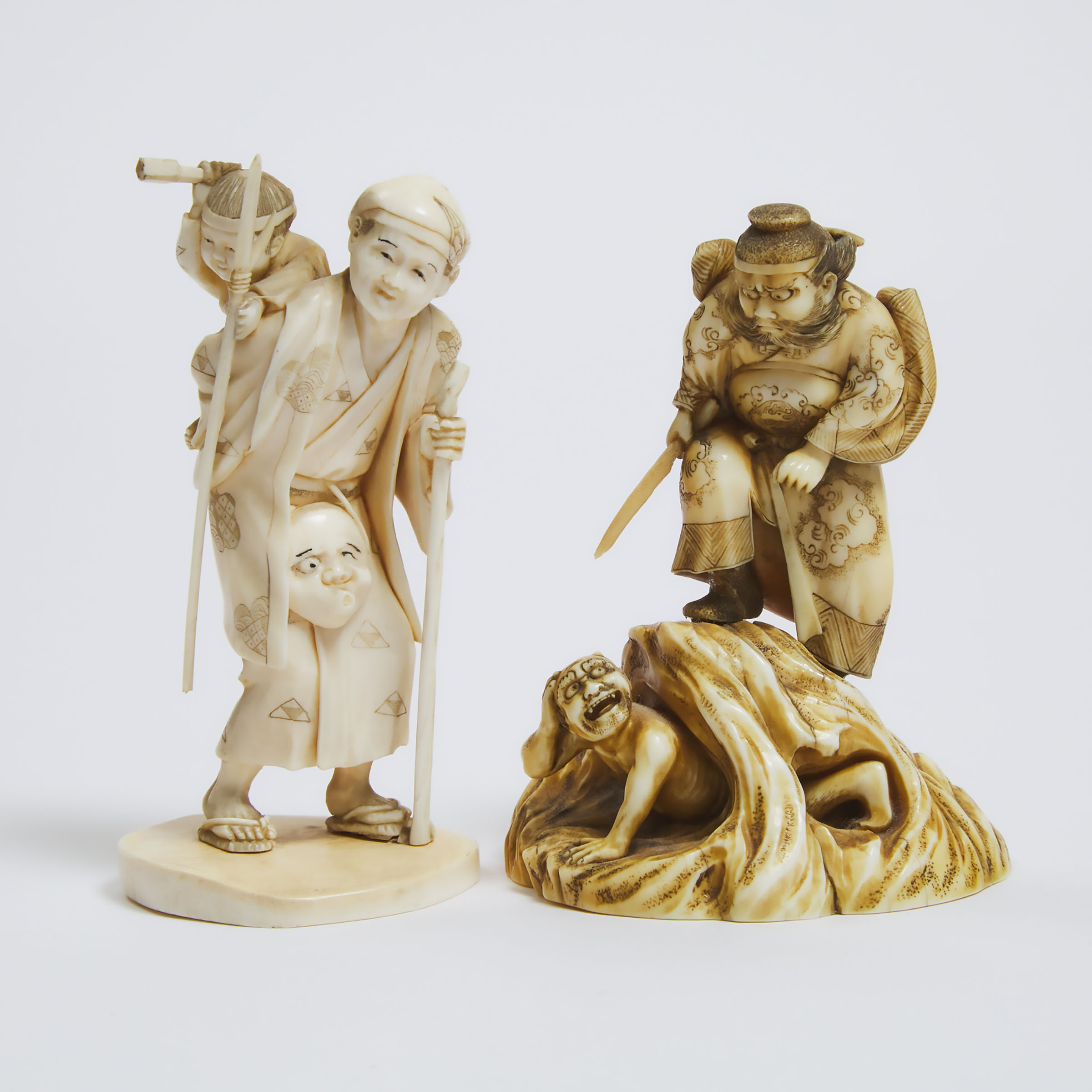Two Fine Ivory Okimono of Shoki Hunting Oni and an Old Man and Child, Meiji Period (1868-1912) 