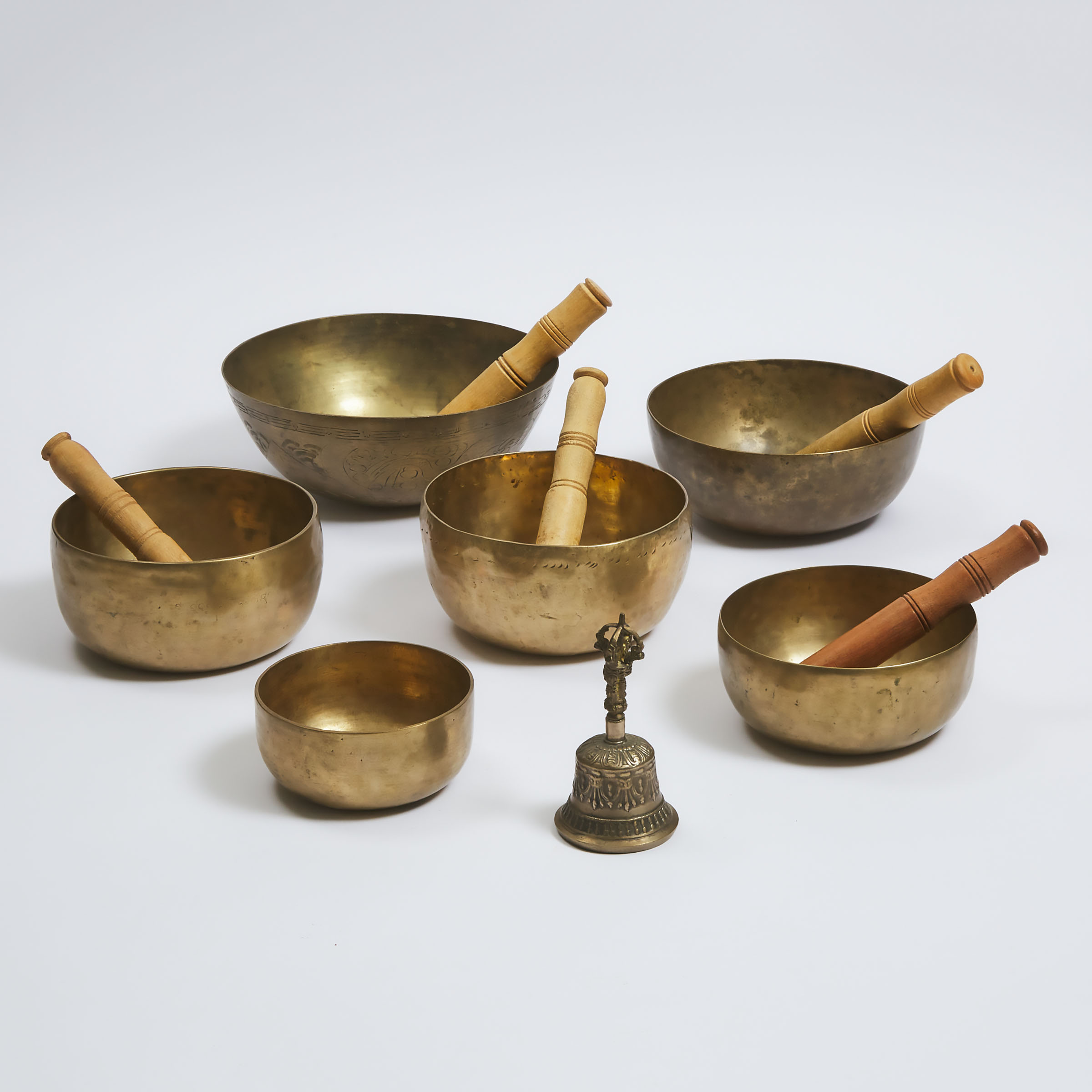 A Group of Six Tibetan Singing Bowls, Together With a Bell