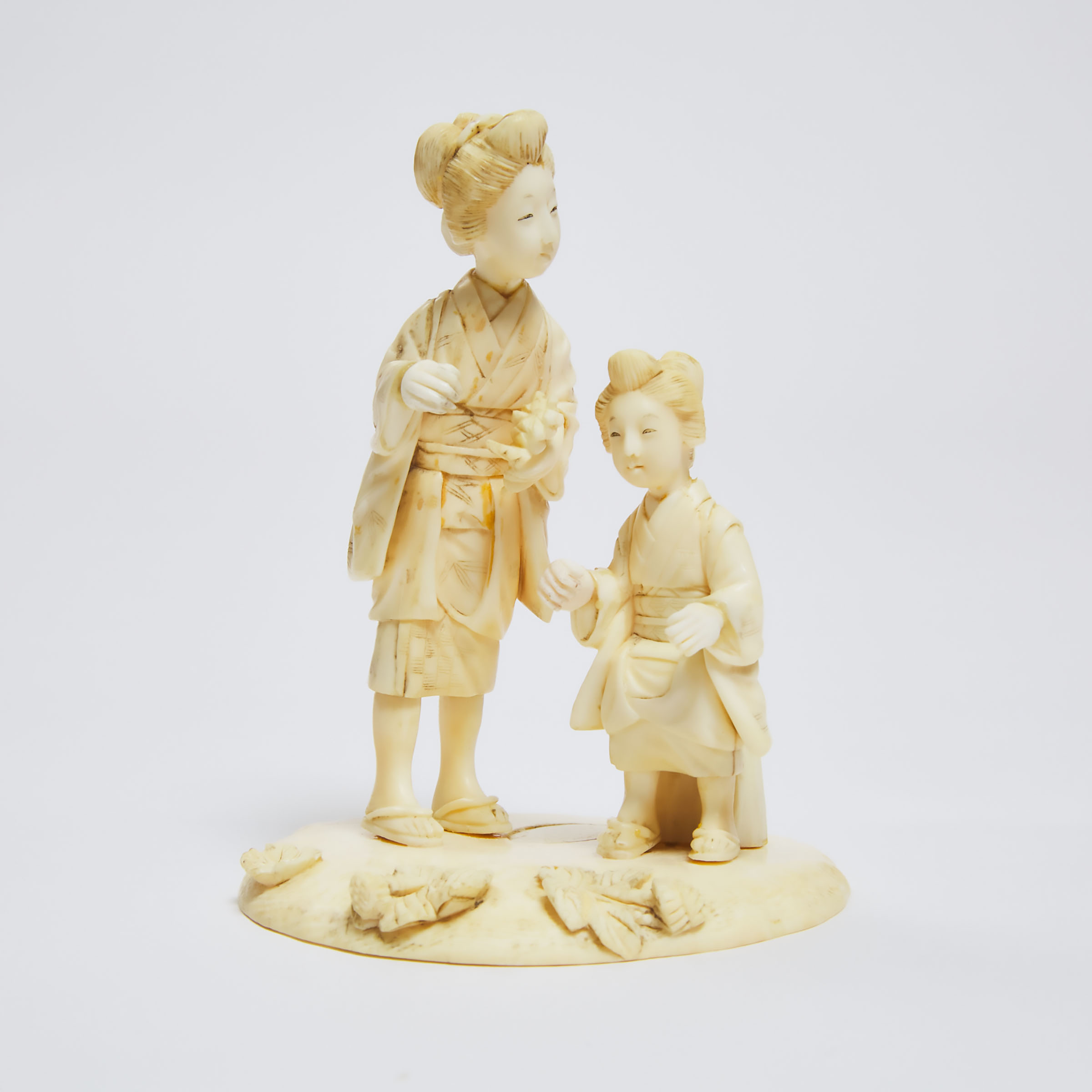 A Japanese Ivory Okimono of A Mother and Child at a Lotus Pond, Signed, Meiji Period 