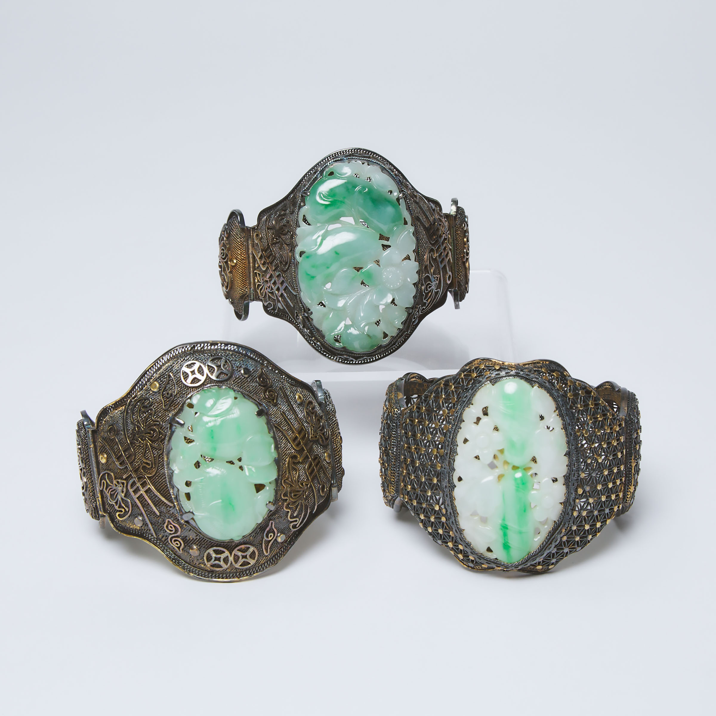 Three Chinese Silver Filigree 'Longevity' Bangles Inset with Carved Jadeite, Qing Dynasty, 19th Century