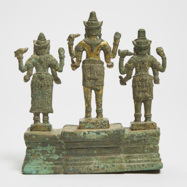 A Khmer Bayon Style Gilt Bronze Triad of Shiva, Vishnu and Devi, With Inscription, 13th Century