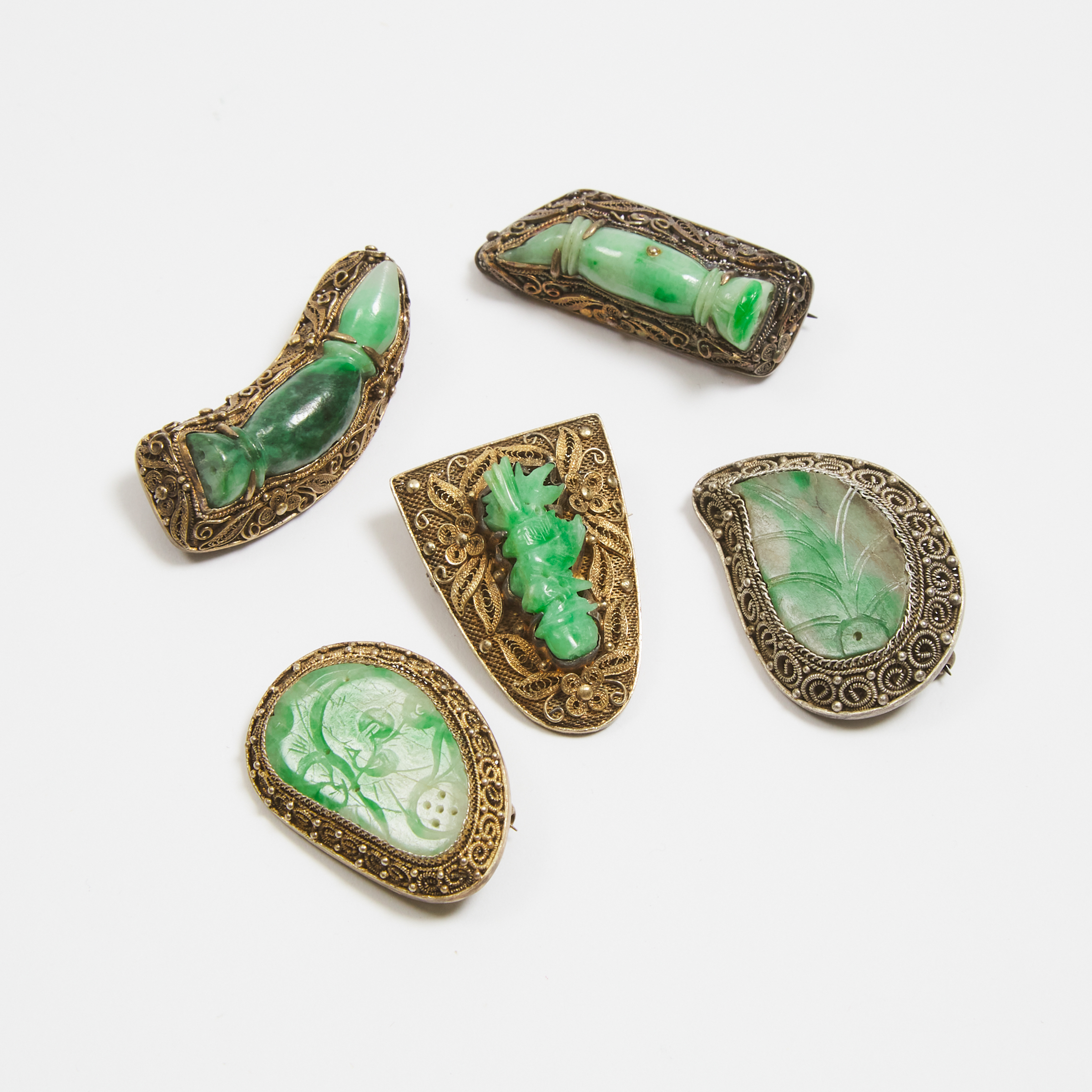 A Group of Five Chinese Silver-Gilt Filigree Brooches with Carved Jadeite Inlays, 19th/20th Century  