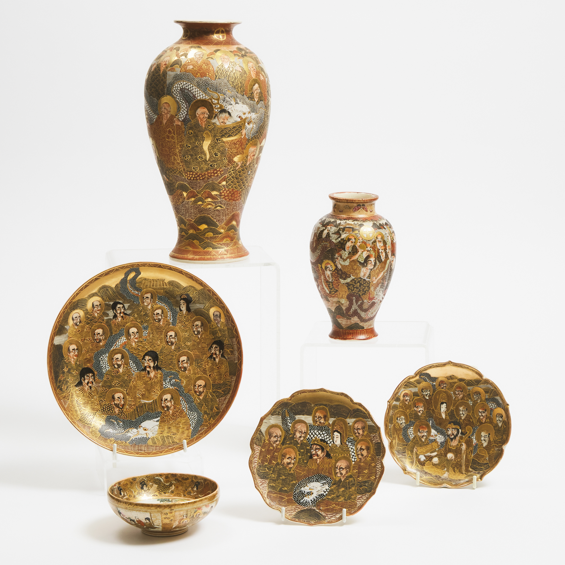 A Group of Six Satsuma 'Buddhist Disciples' Vases, Chargers and Bowl, Meiji/Taisho Period (1868-1926)