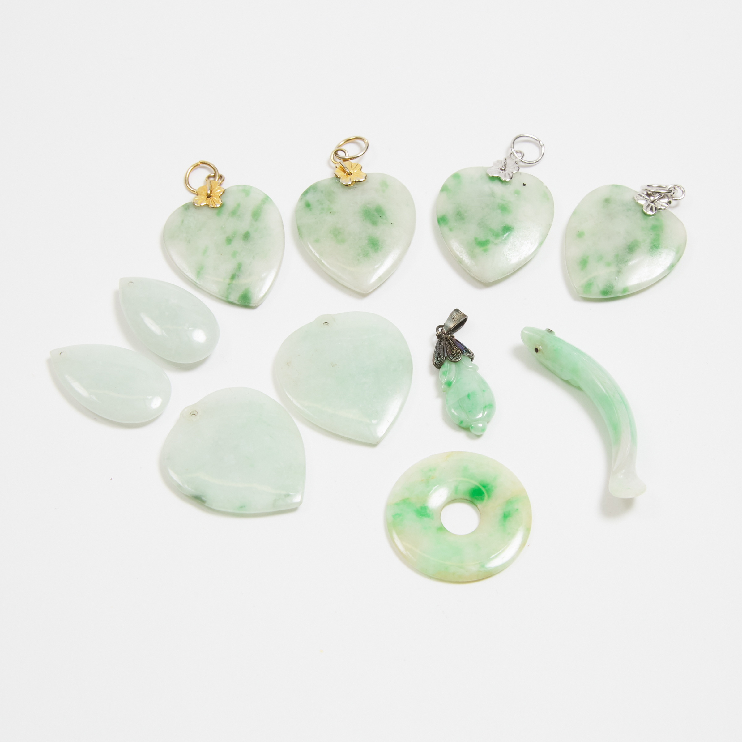 A Group of Eleven Jadeite Pendants, Early to Mid 20th Century