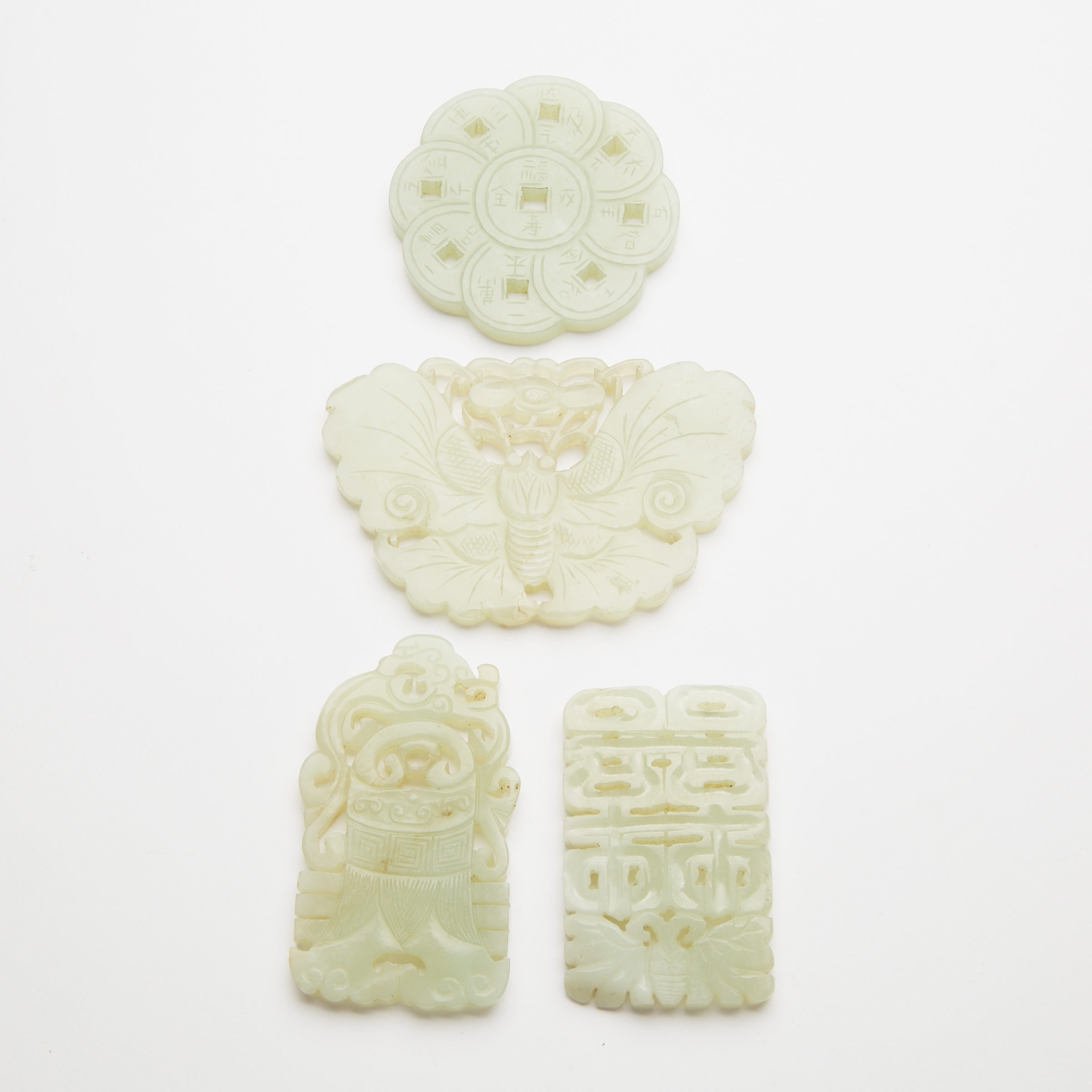 A Group of Four White Jade Reticulated Plaques, Qing Dynasty, 19th Century