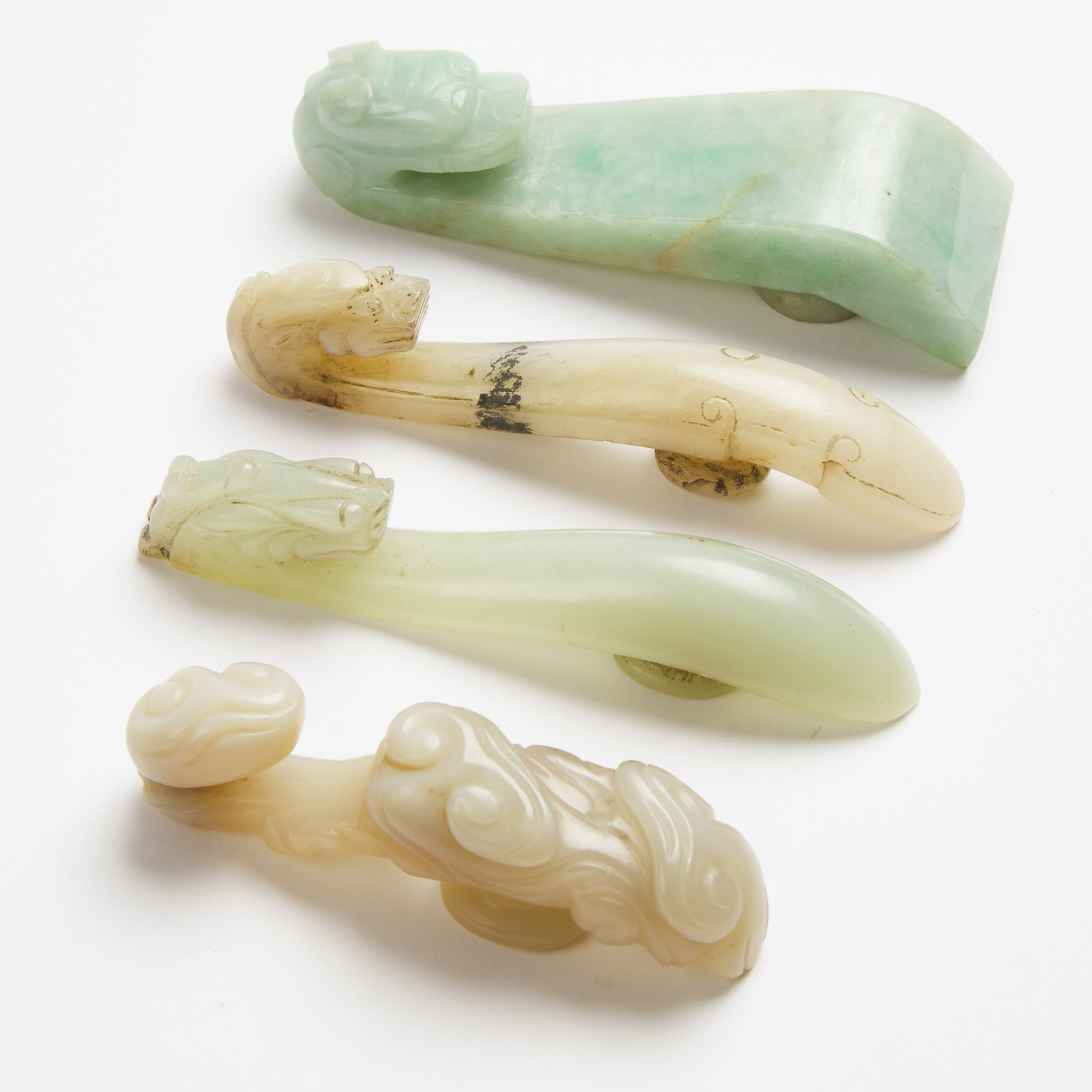 A Group of Four Jade and Jadeite Belt Hooks, Qing Dynasty, 19th Century