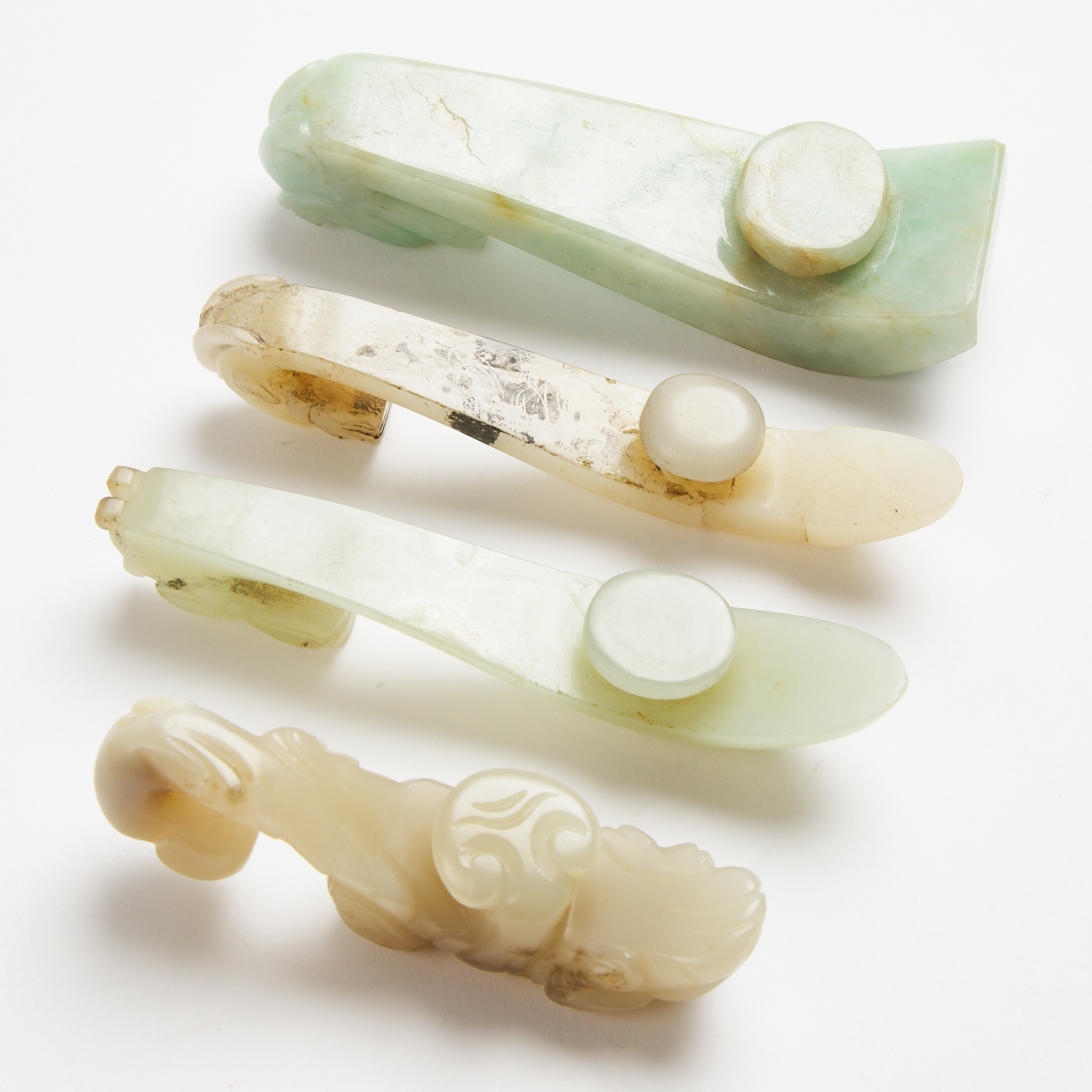 A Group of Four Jade and Jadeite Belt Hooks, Qing Dynasty, 19th Century