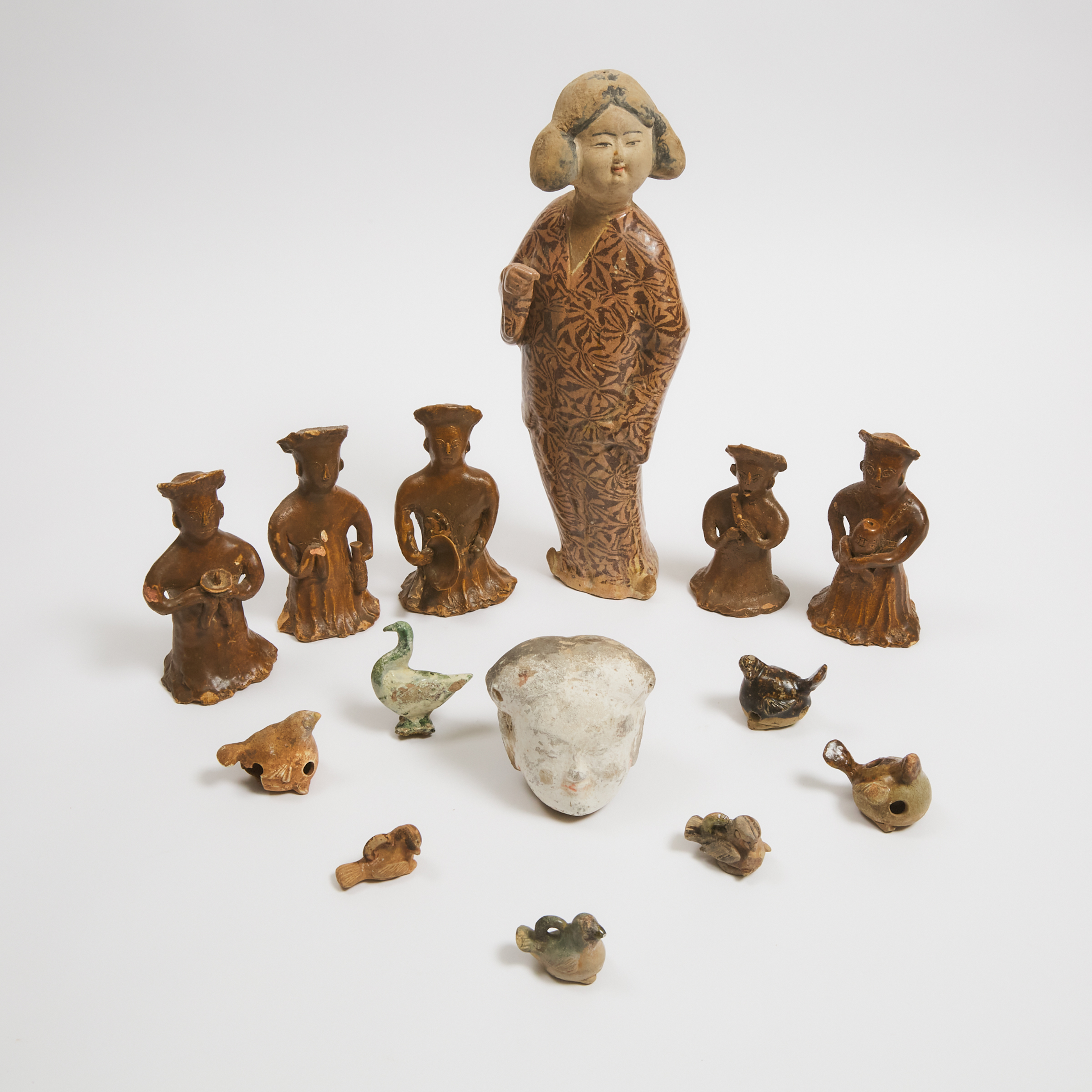 A Group of Fourteen Glazed Pottery Figures and Animals, Han Dynasty and Later