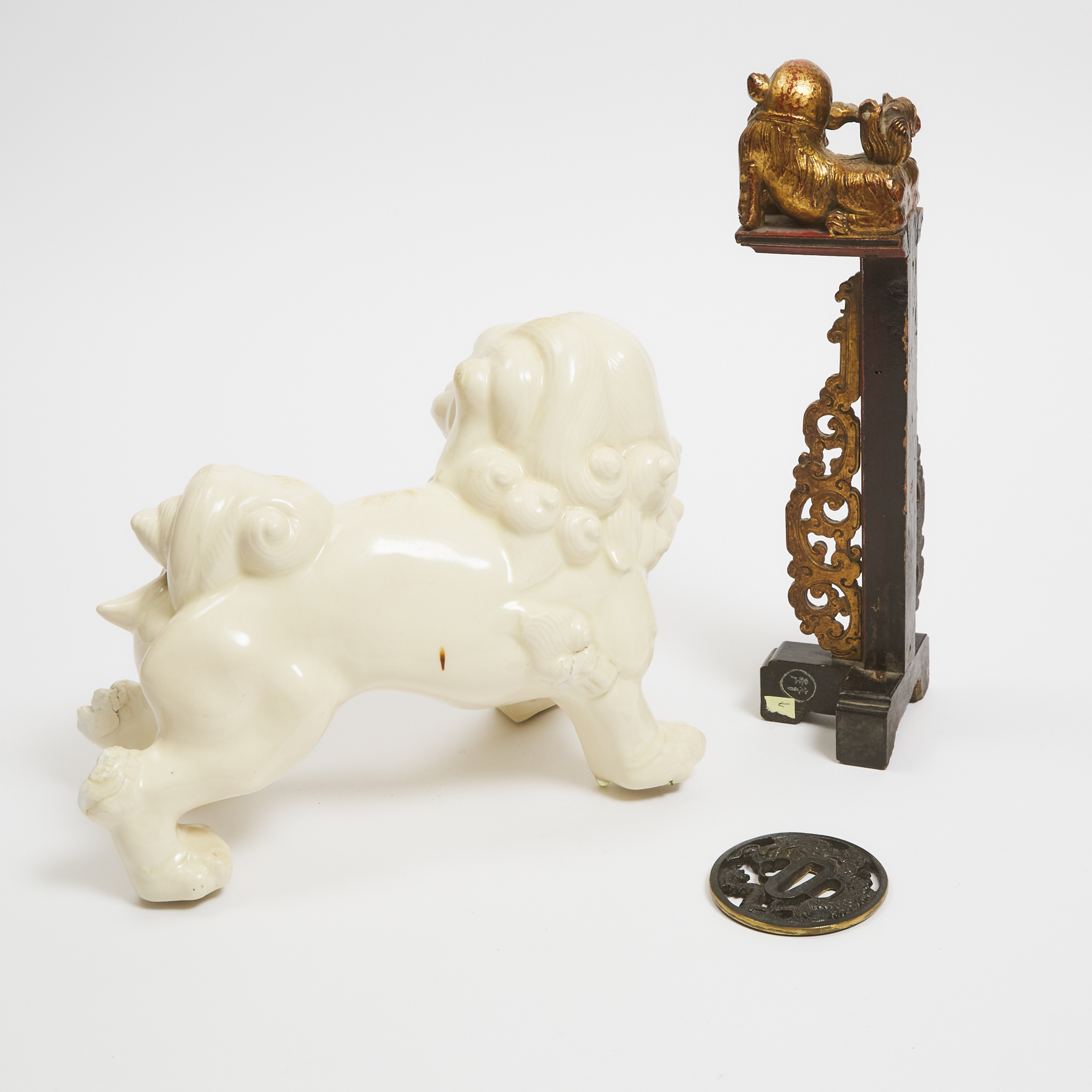 A White Glazed Ceramic Foo Dog, Together With a Gilt Wood Bracket and a Japanese Tsuba, 19th/20th Century
