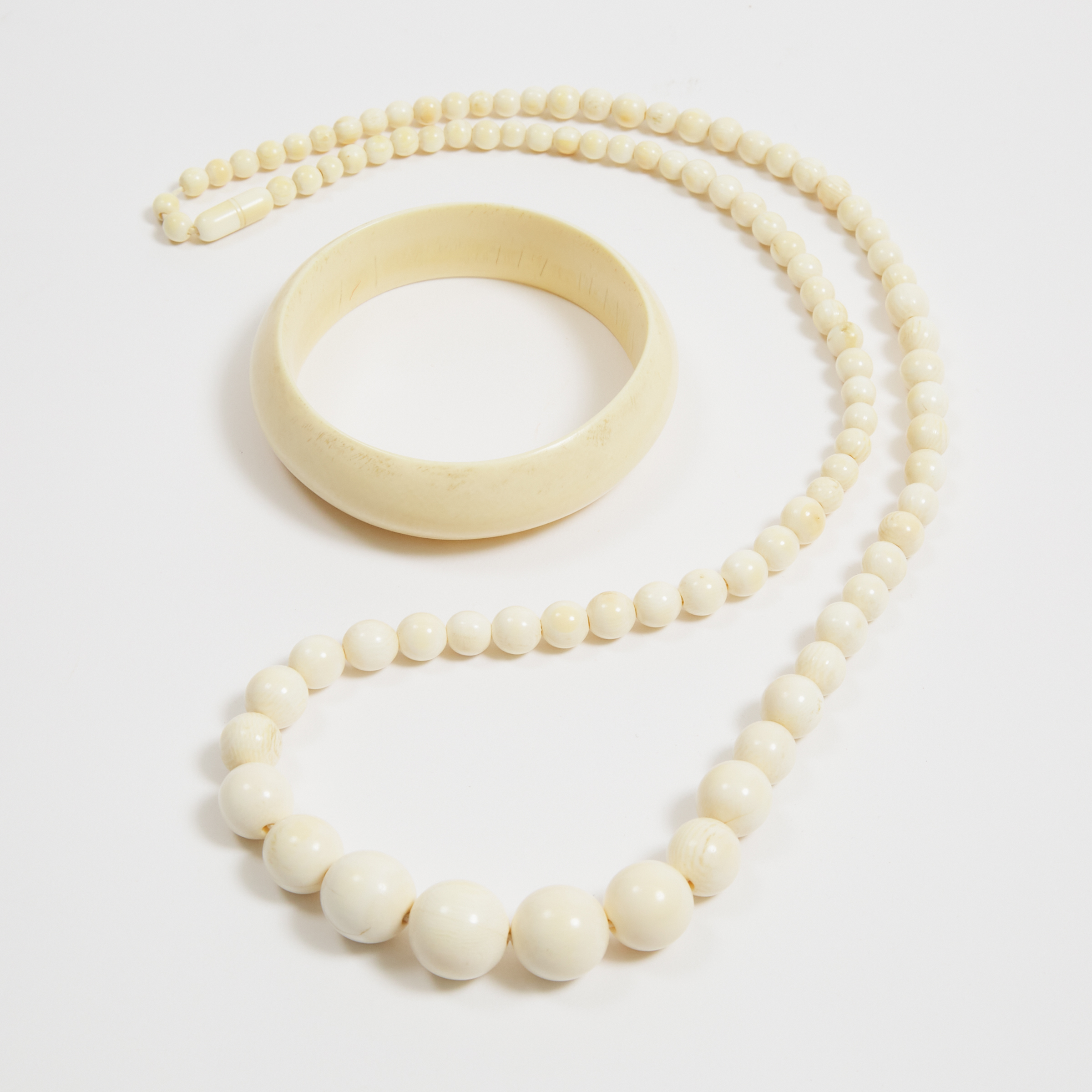 An Ivory Beaded Necklace and Bangle, Early 20th Century