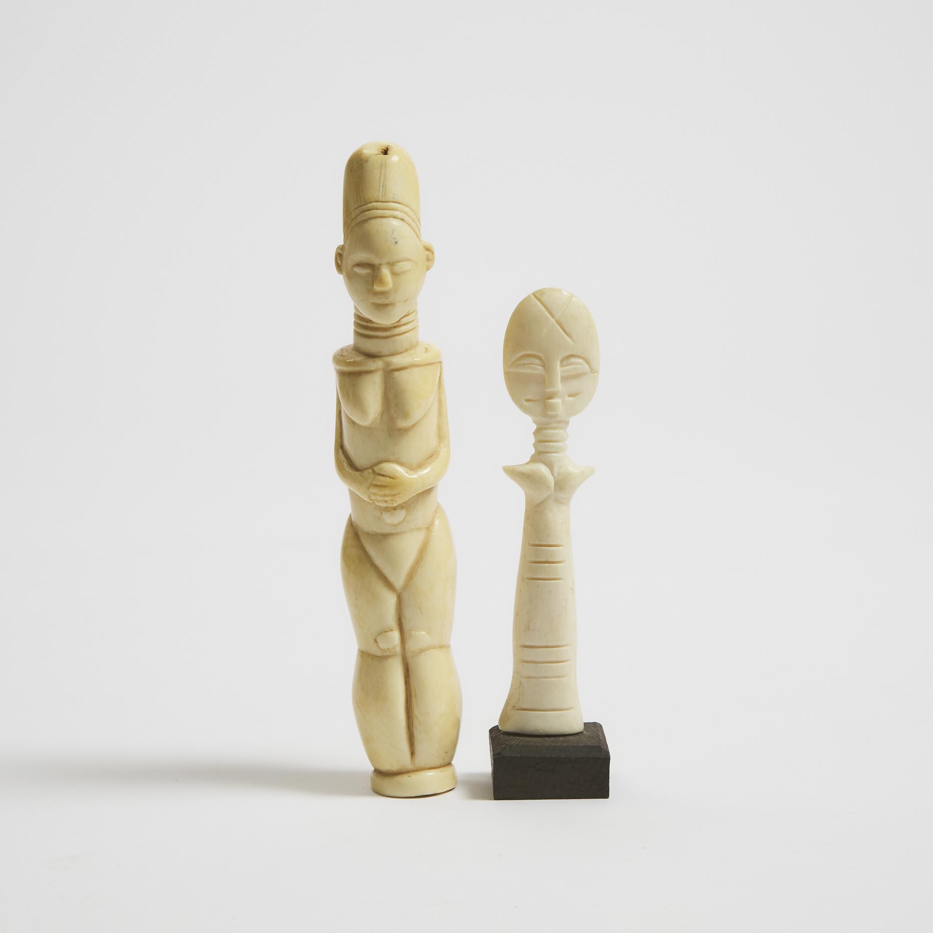 Mangbetu Carved Ivory Female Figure, Democratic Republic of Congo, Central Africa, late 19th to early 20th century together with a small Ashanti Akuaba (Fertility) Ivory Figure, Ghana, West Africa, mid 20th century