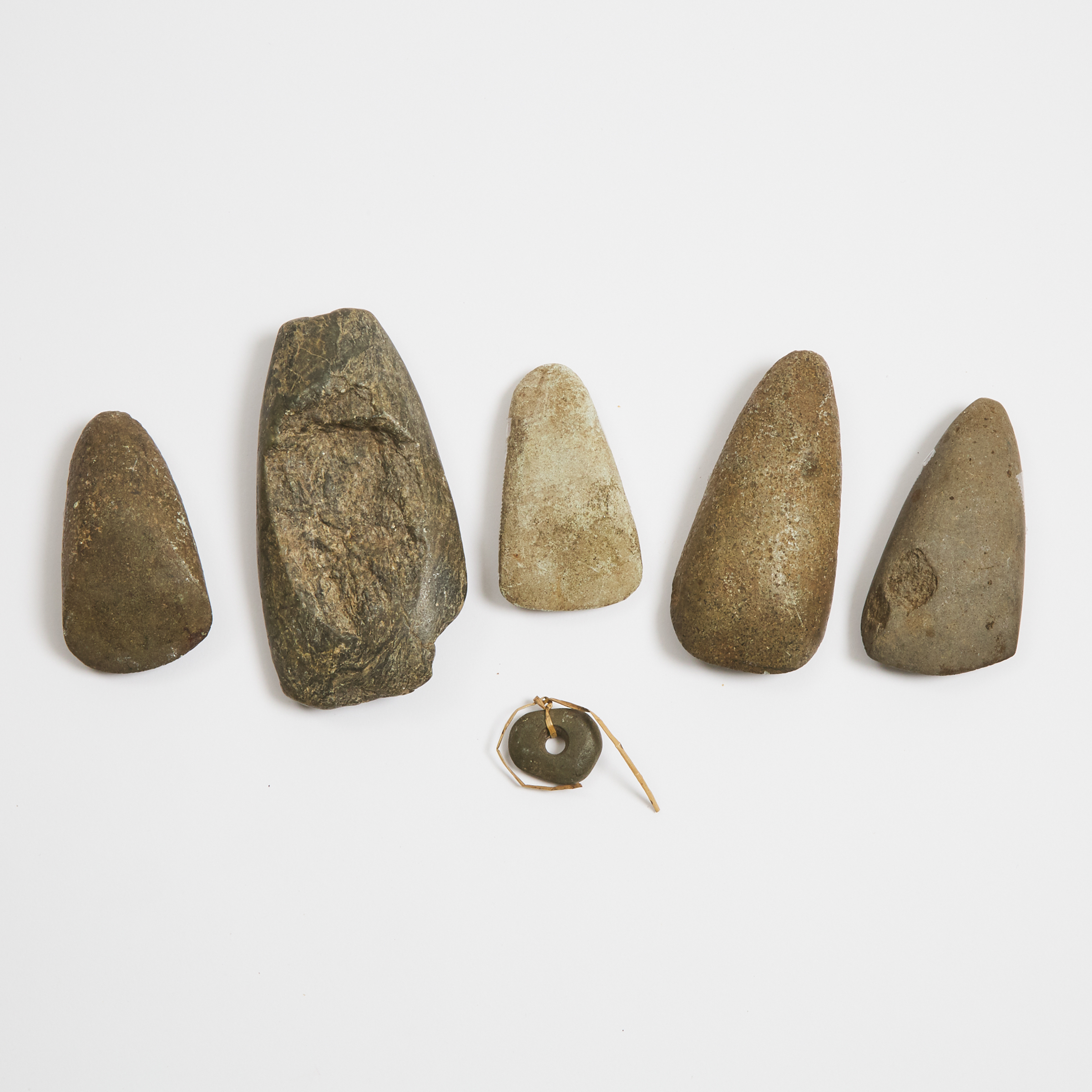 Group of Five New Hebrides (Vanuatu) Stone Adze Axe Heads together with a stone amulet, Melanesia, 19th/20th century