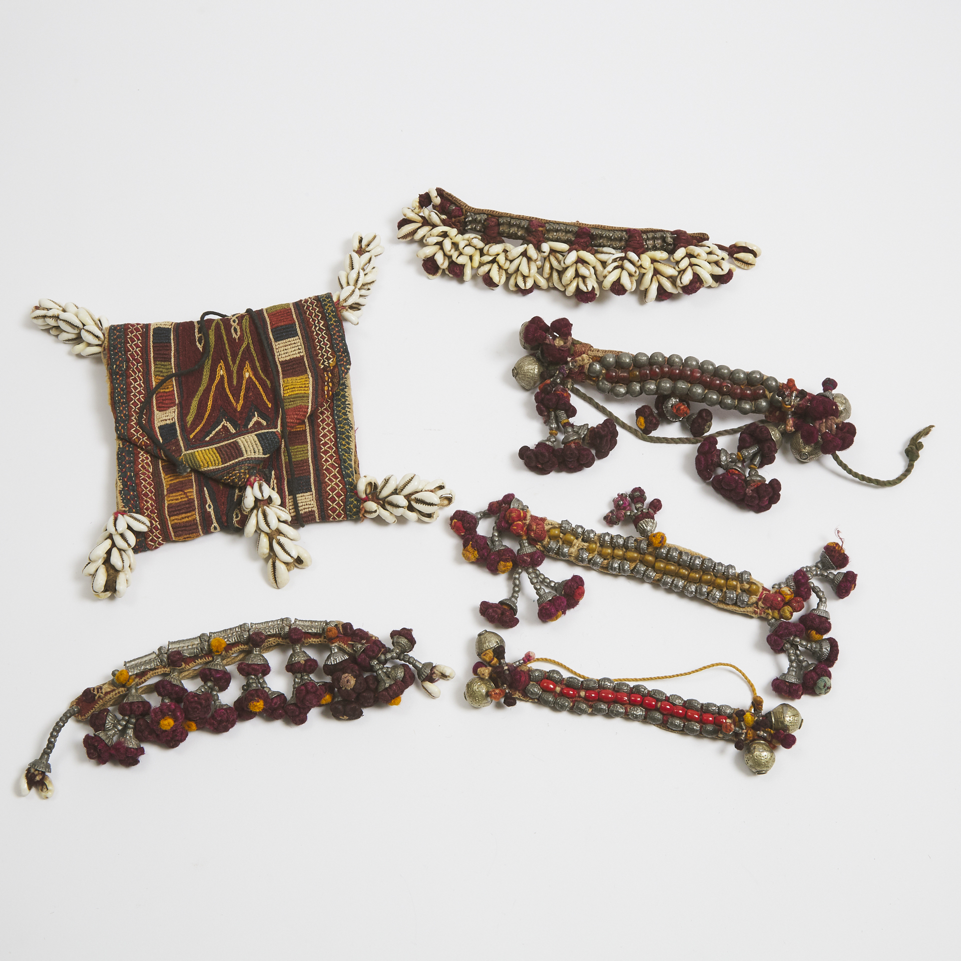 Group of Five Banjara Armlets together with a folding pouch, Goa, India, mid 20th century