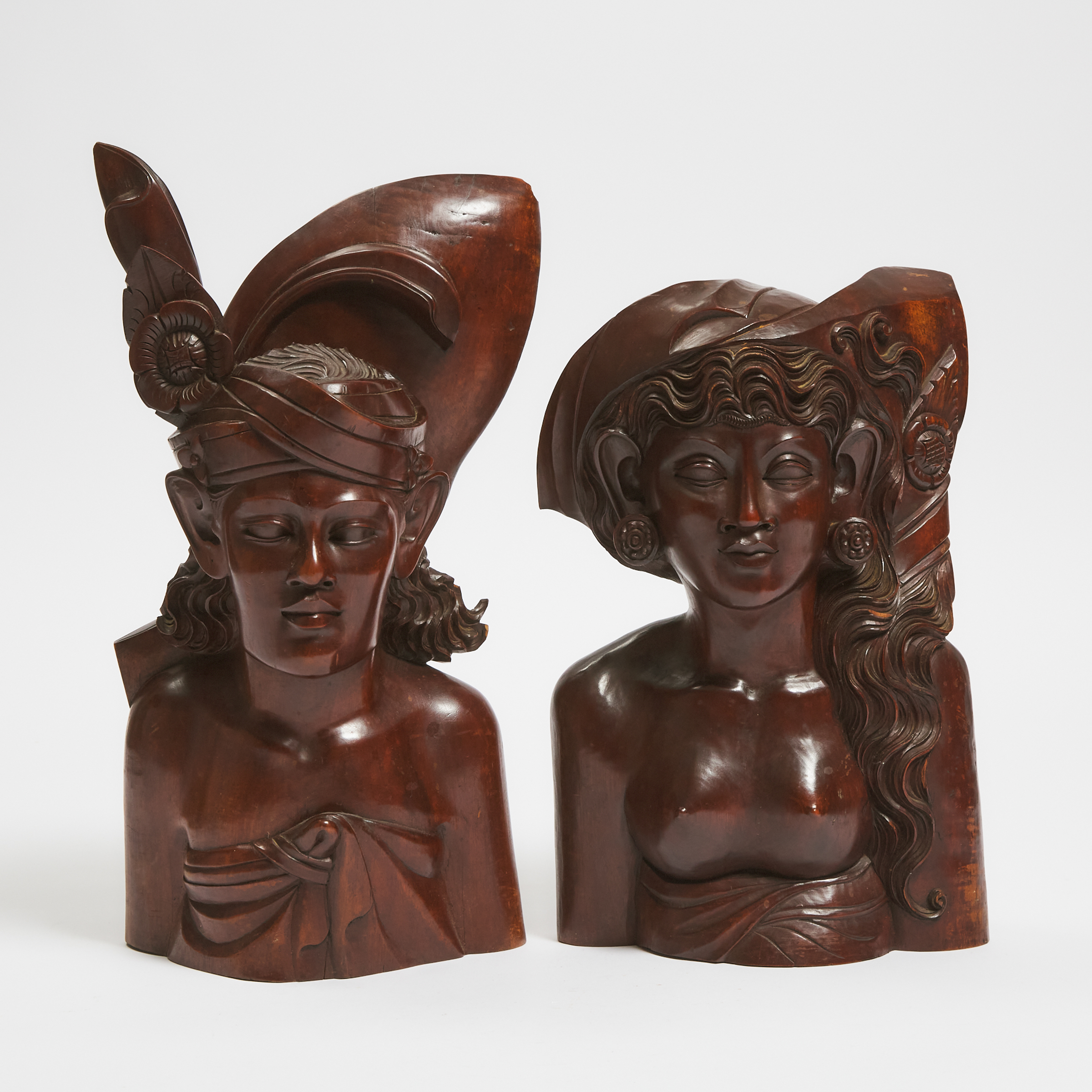 Two Balinese Carved Hardwood Male and Female Busts, late 20th century