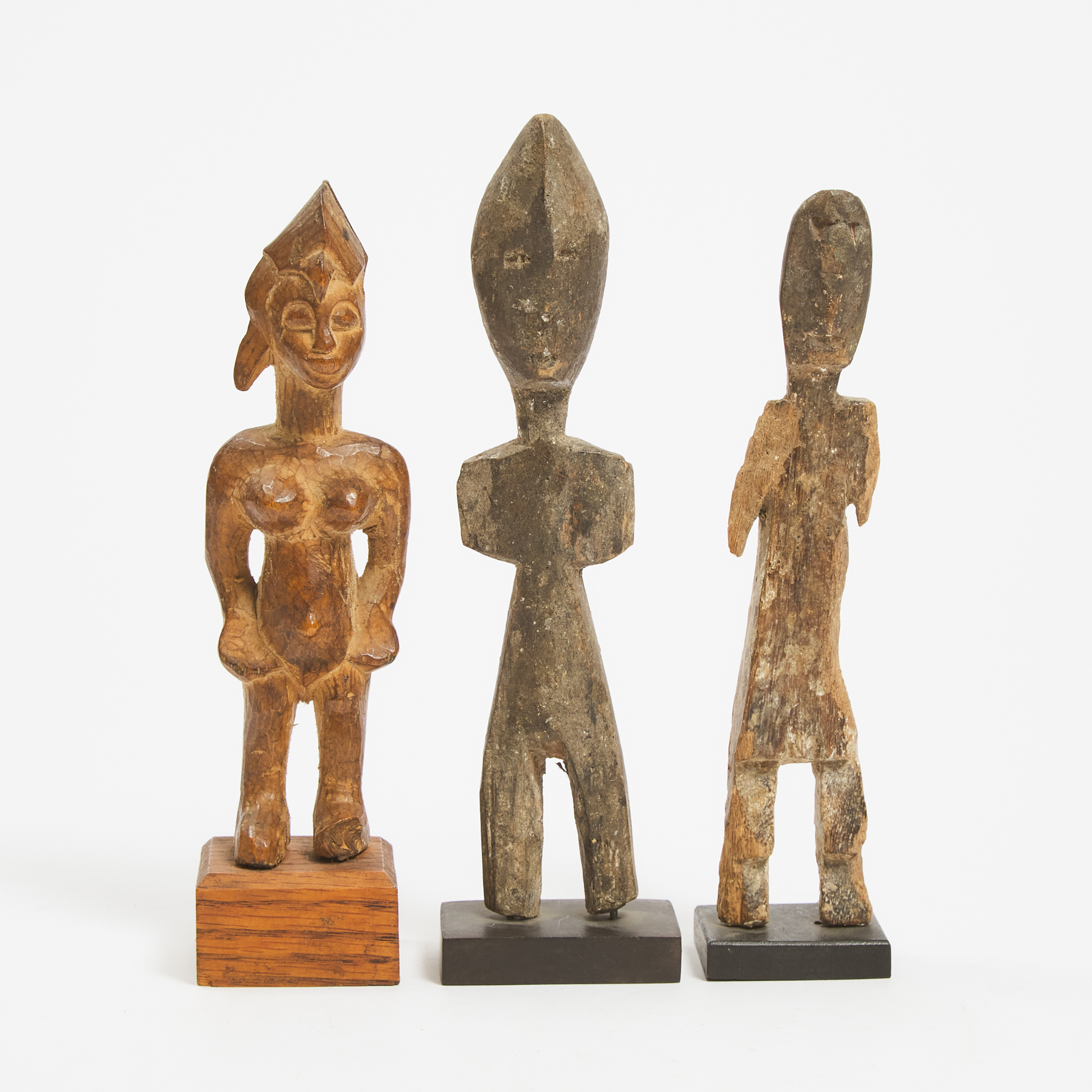 Senufo Female Figure, South Africa together with two unidentified African figures, 20th century, two possibly 19th century