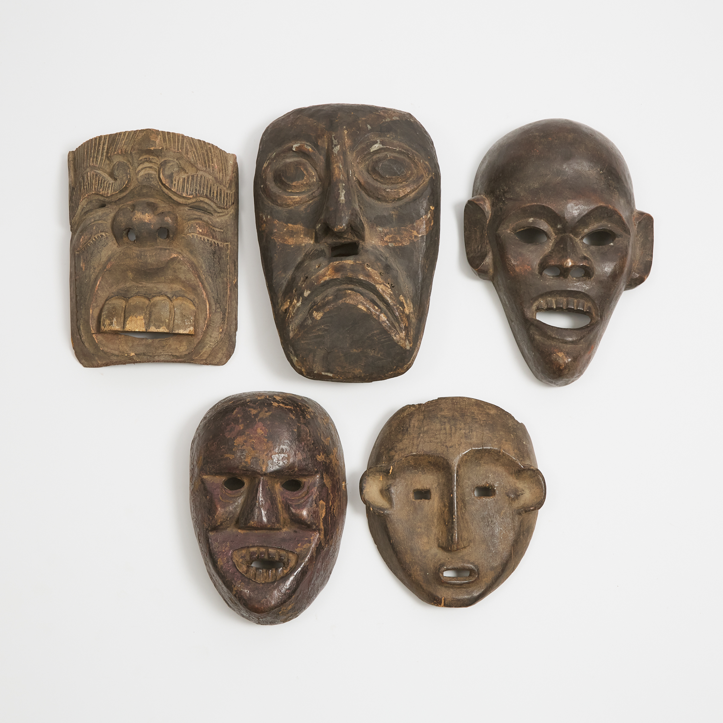 Group of Five Indonesian Masks, including three Batak/Iban/Dayak examples, 20th century