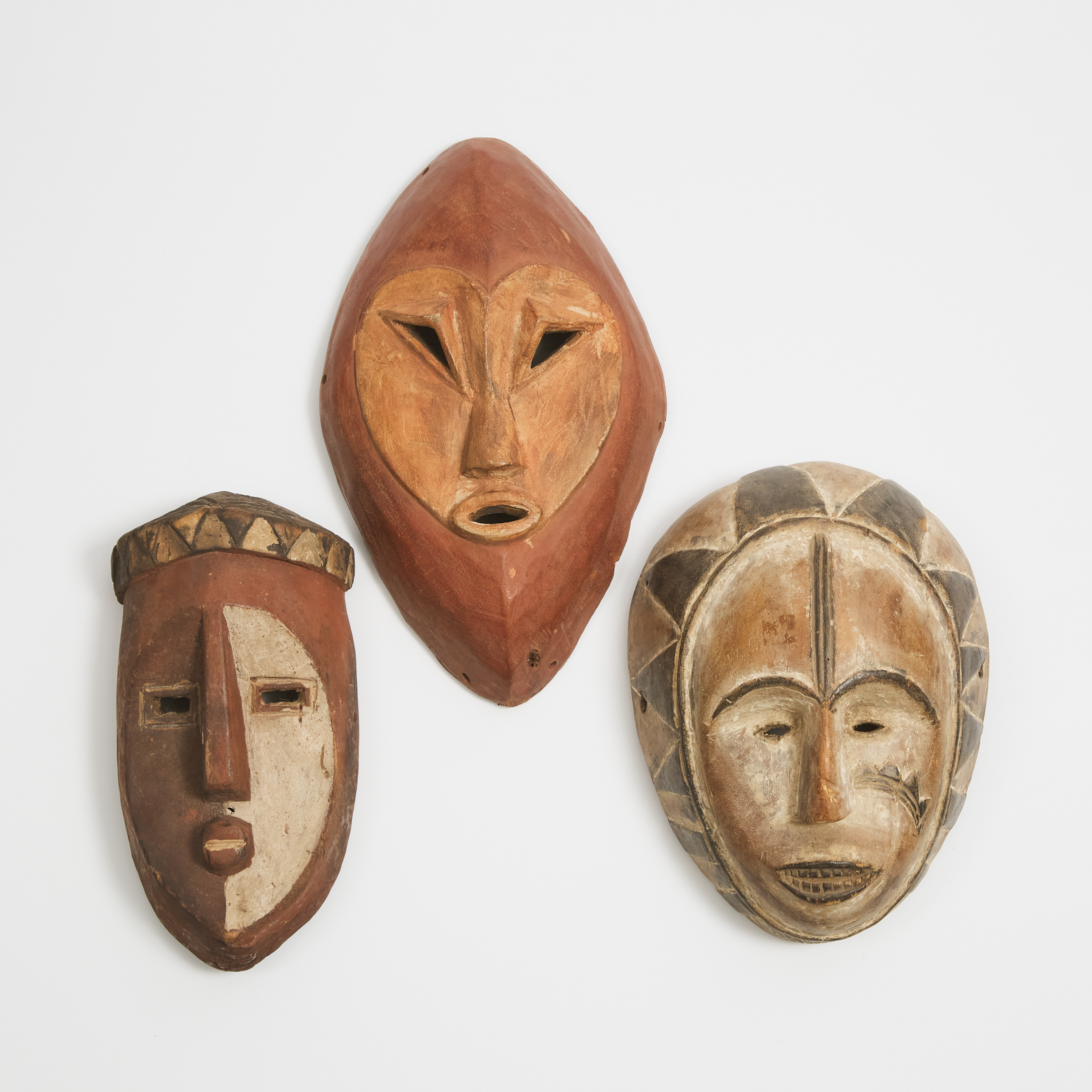 Group of Three African Painted Masks, one possibly Gabon, all 20th century