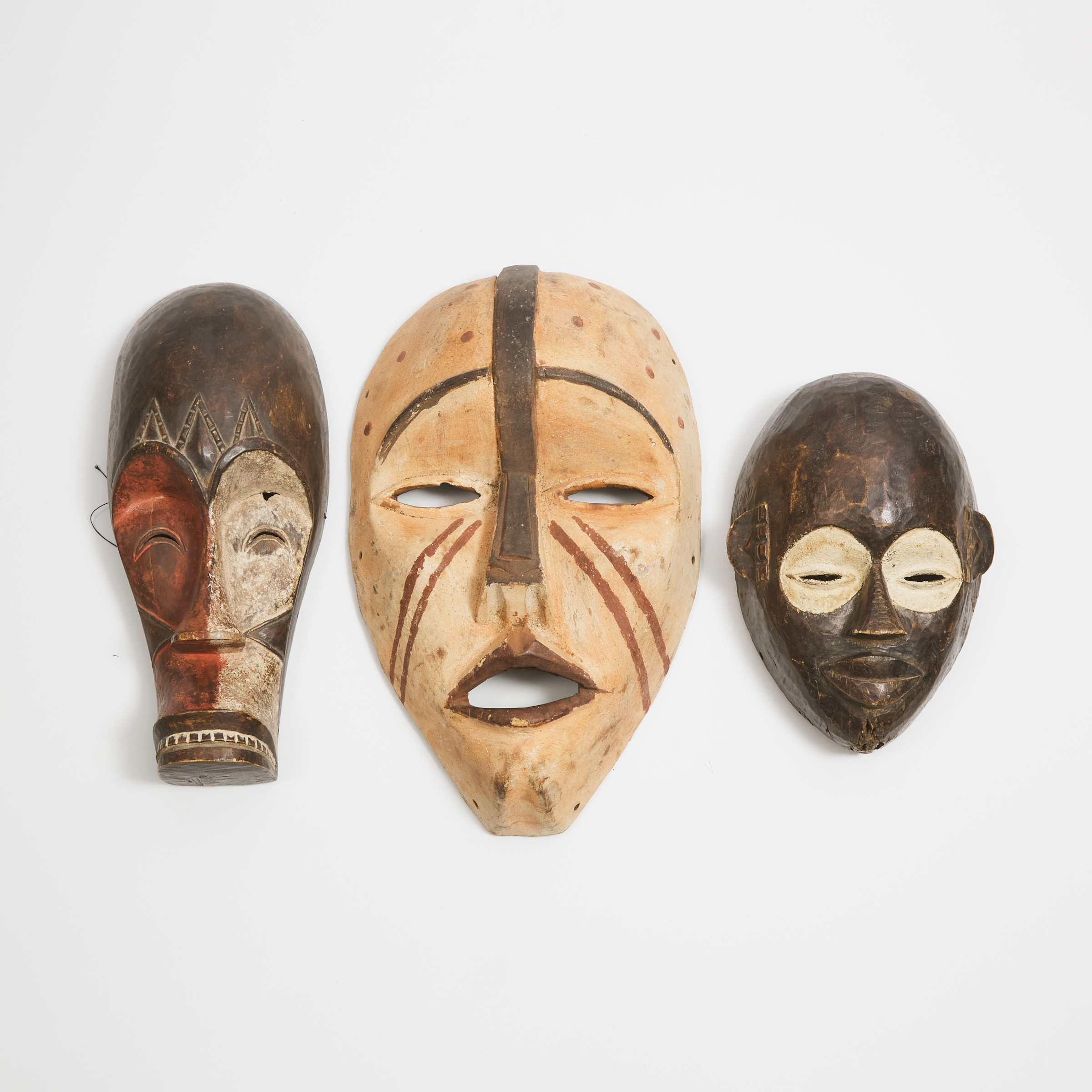 Group of Three African Masks including one Fang and one Kongo mask, 20th century