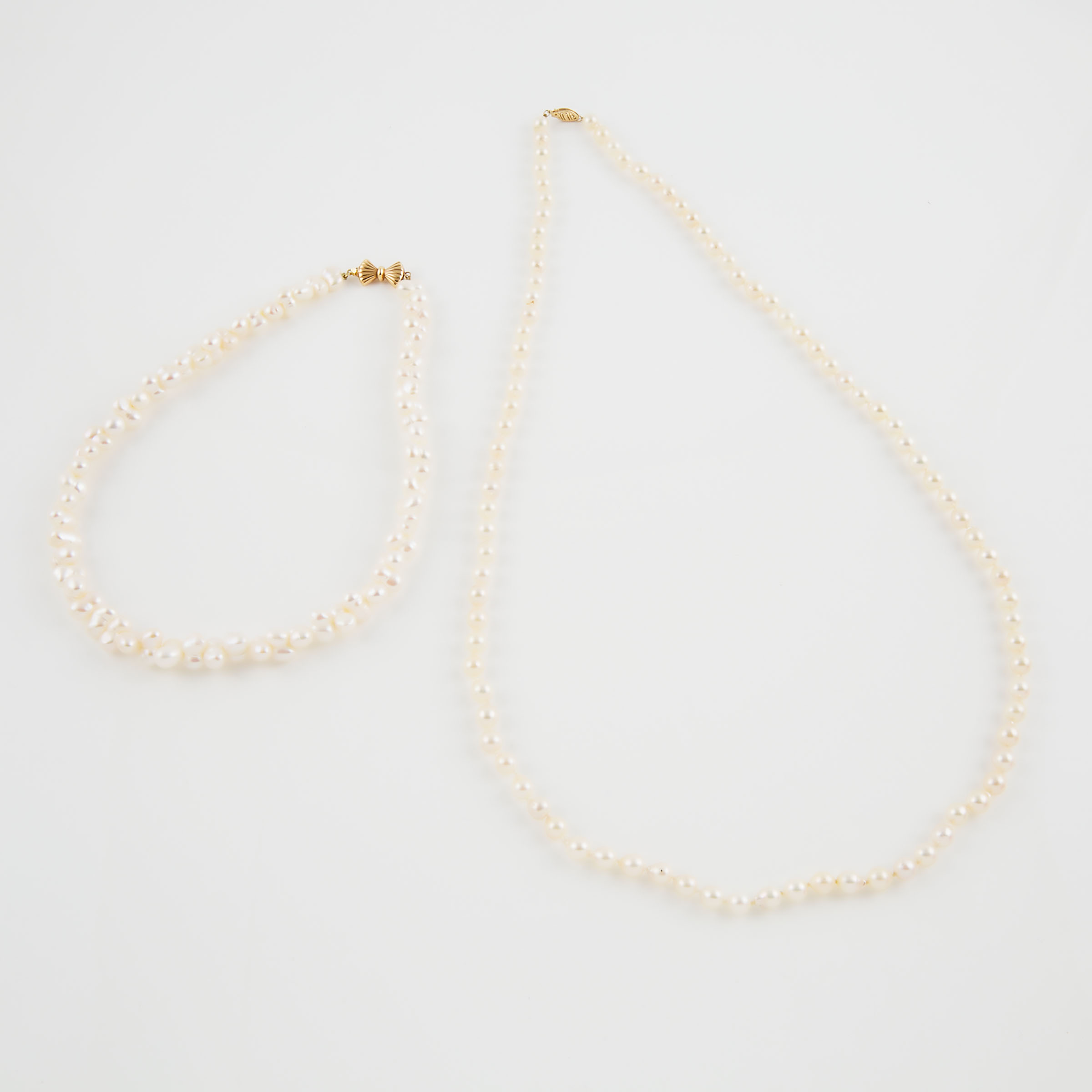 Two Single Strands Of Pearls