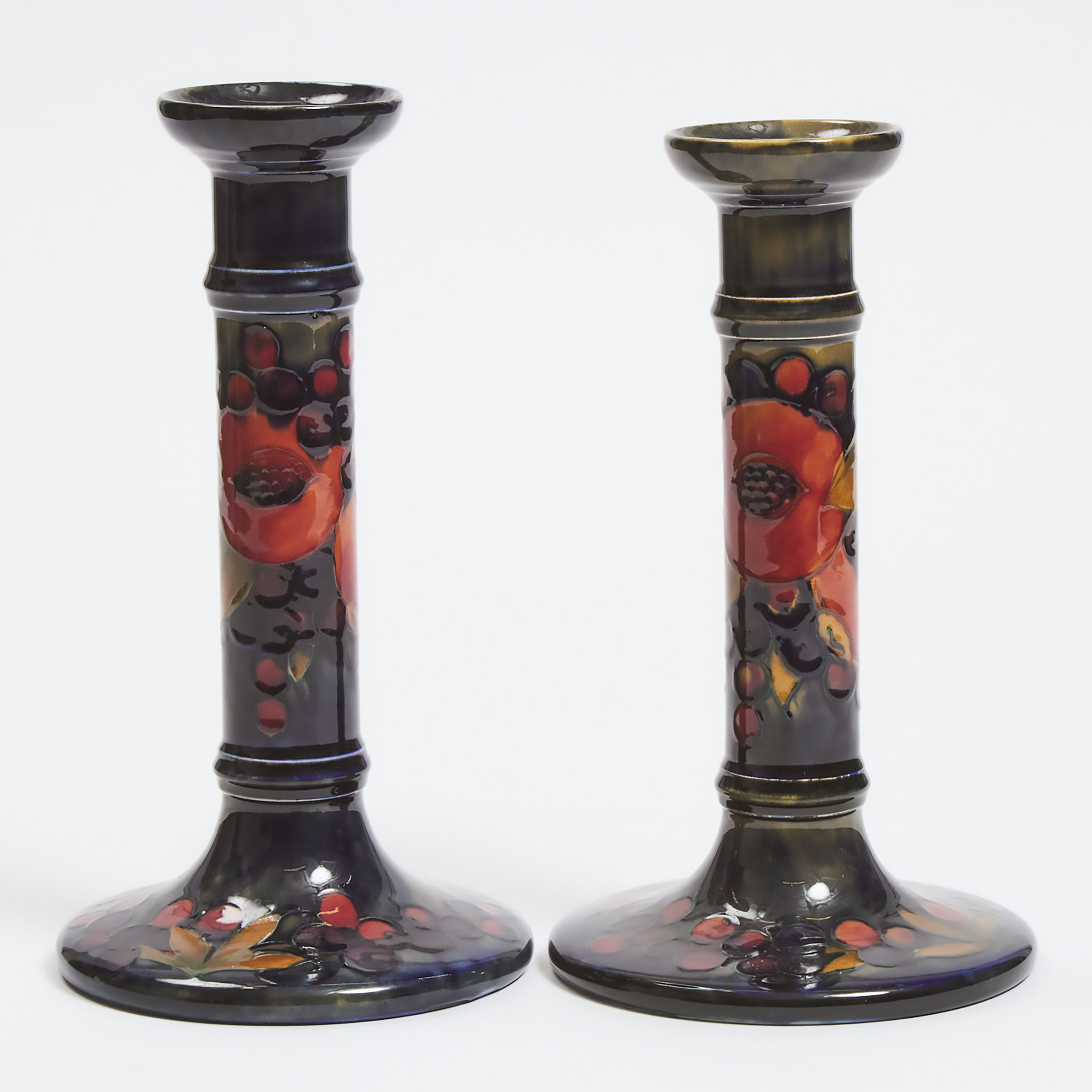 Two Large Moorcroft Pomegranate Table Candlesticks, c.1925
