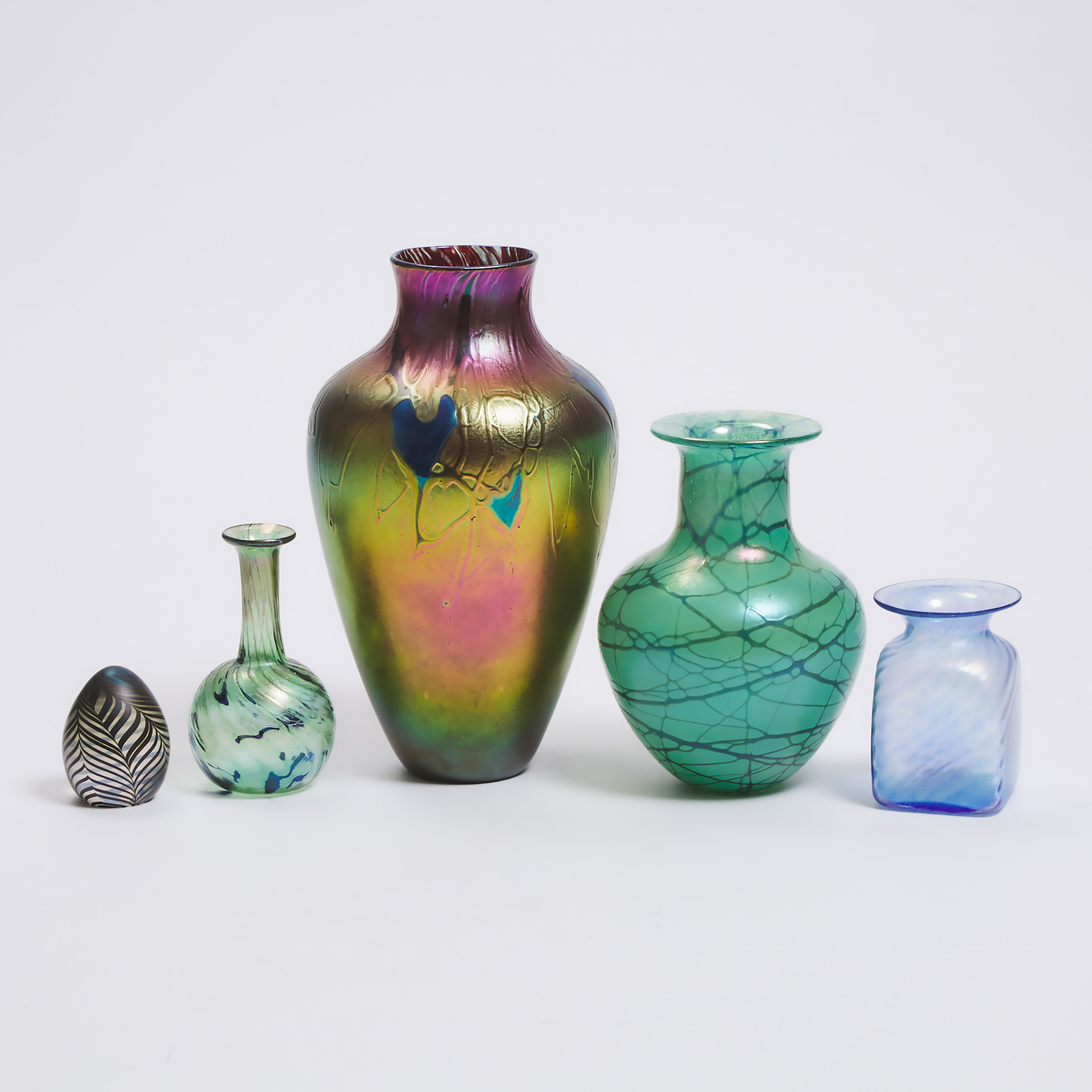 Four Robert Held and Skookum Iridescent Glass Vases and a Paperweight, late 20th century