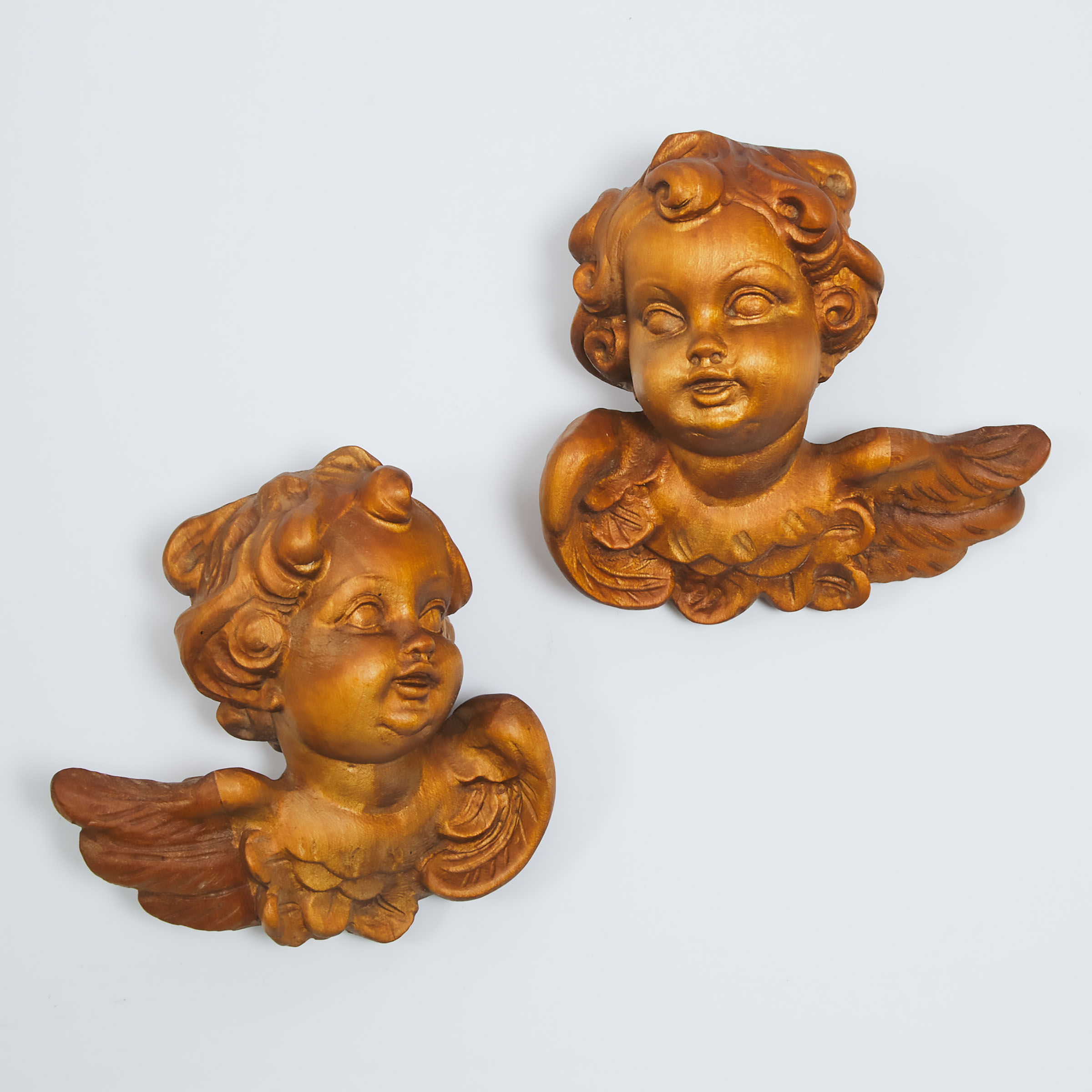 Pair of Italian Baroque Style Carved Walnut Winged Cherubic Heads, mid 20th century