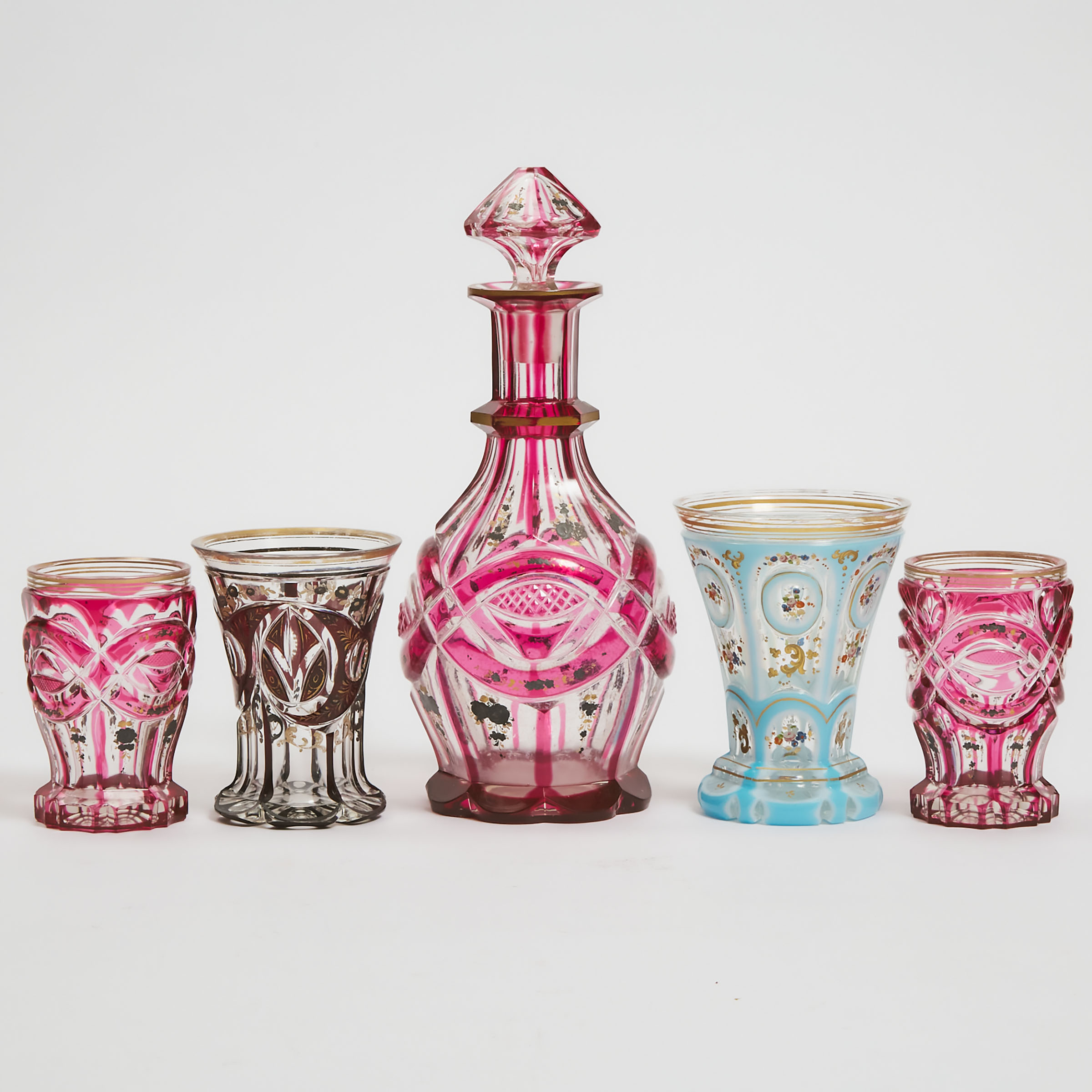 Four Bohemian Overlaid, Cut and Enameled or Gilt Glass Beakers and a Decanter, late 19th century