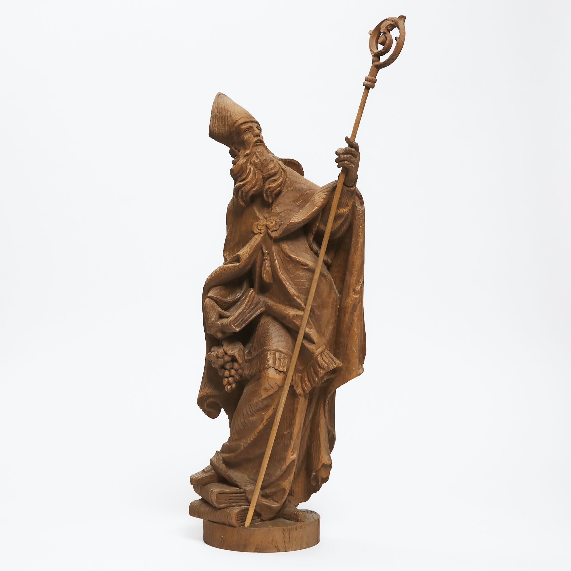 Gothic Style Carved Oak Figure of a Bishop with Crozier, Books and Grapes, Josef 'Peppi' Rifesser (Italian, 1921-2020), mid 20th century