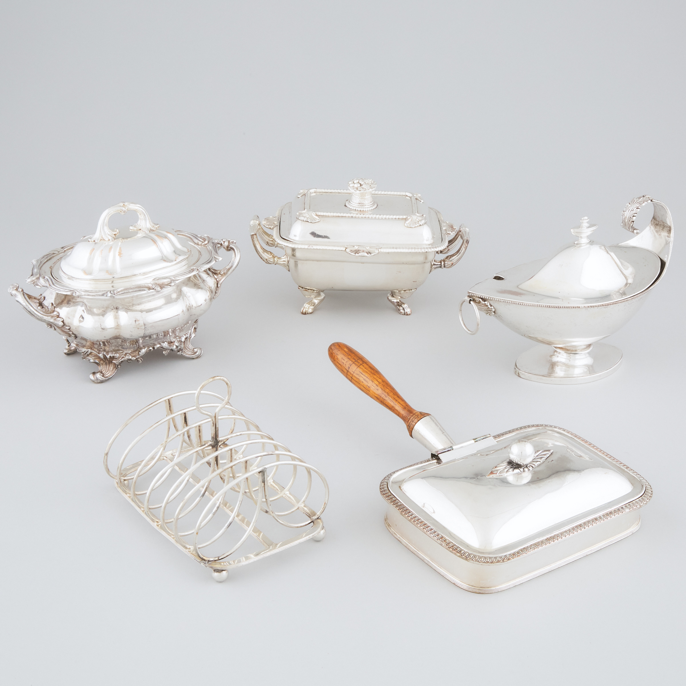 Three Old Sheffield Plate Covered Sauce Tureens, Welsh Rarebit Dish and a Toast Rack, 19th century