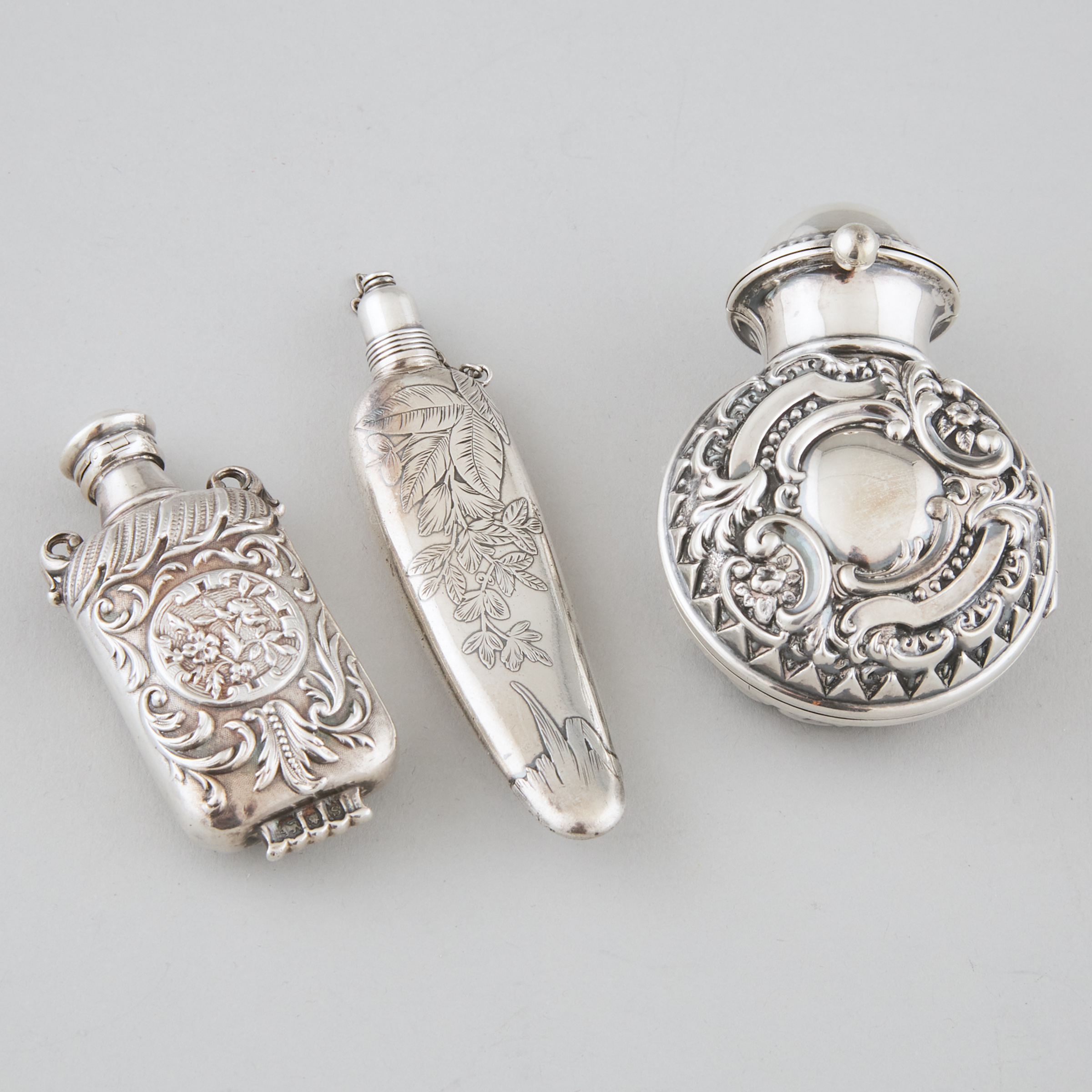 Three Victorian, Edwardian and American Silver Perfume Bottles, late 19th/early 20th century