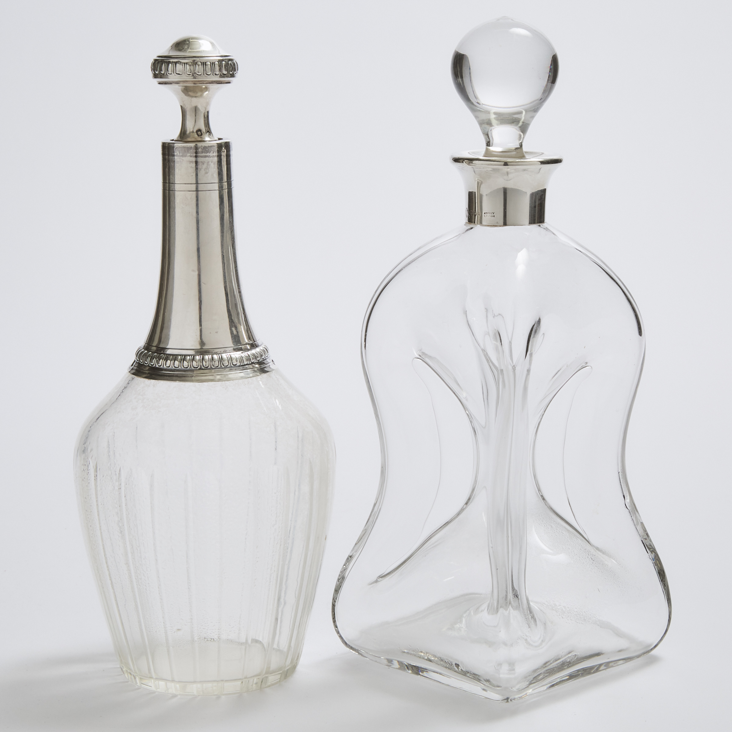 Two French or English Silver Mounted Glass Decanters, Charles Tirbour, Paris and Asprey & Co., London, 20th century