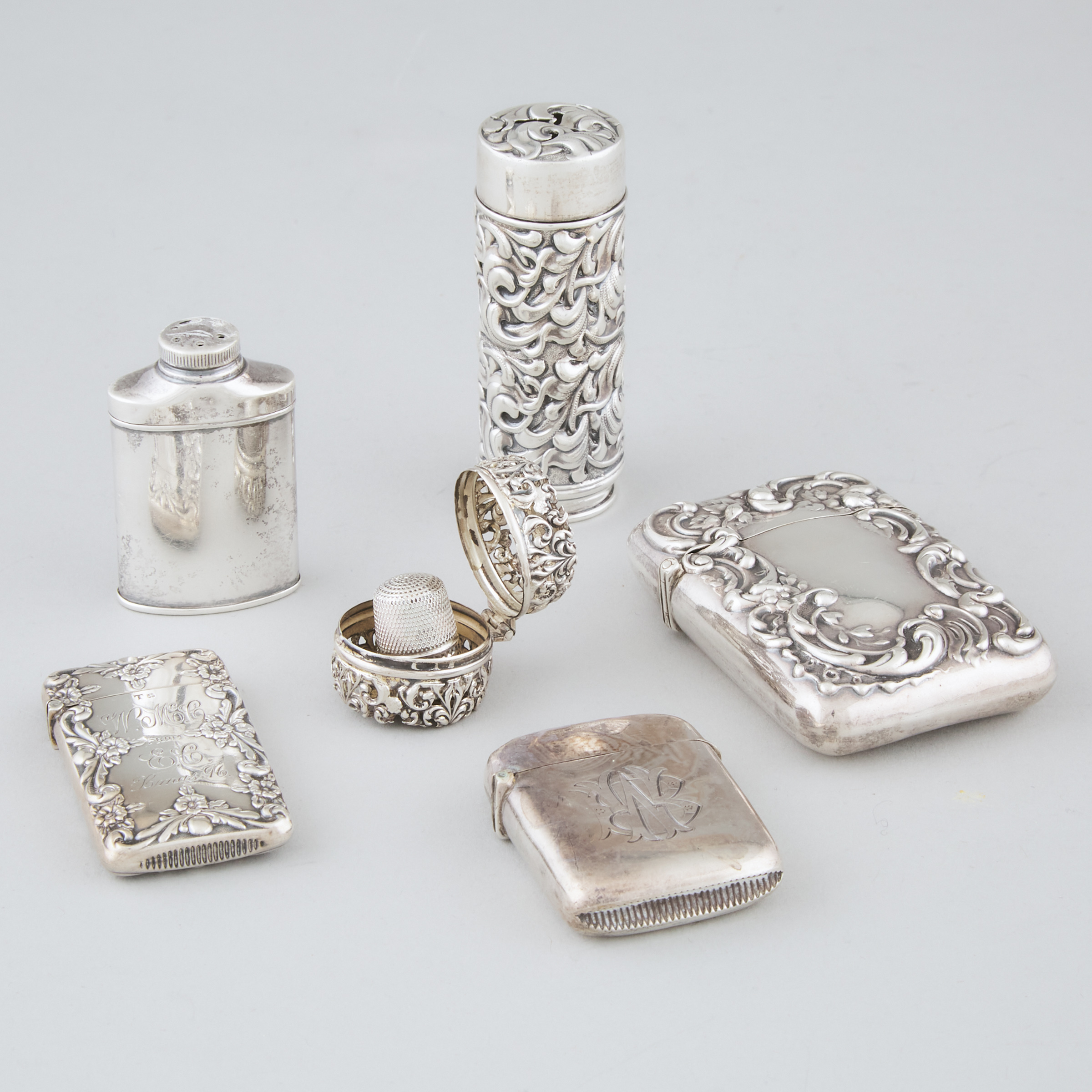 Two English and American Silver Vesta Cases, a Card Case, Thimble Case, and Two Casters, late 19th/early 20th century