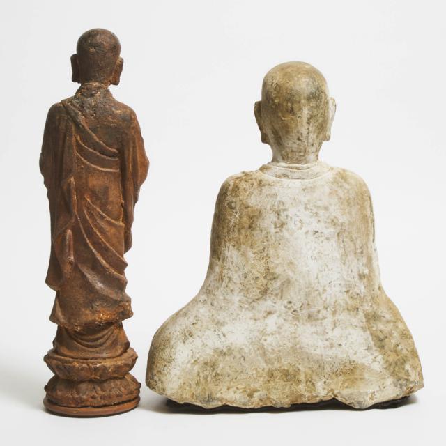 A Stone Figure of a Seated Monk, Together With an Iron Figure of a Standing Monk