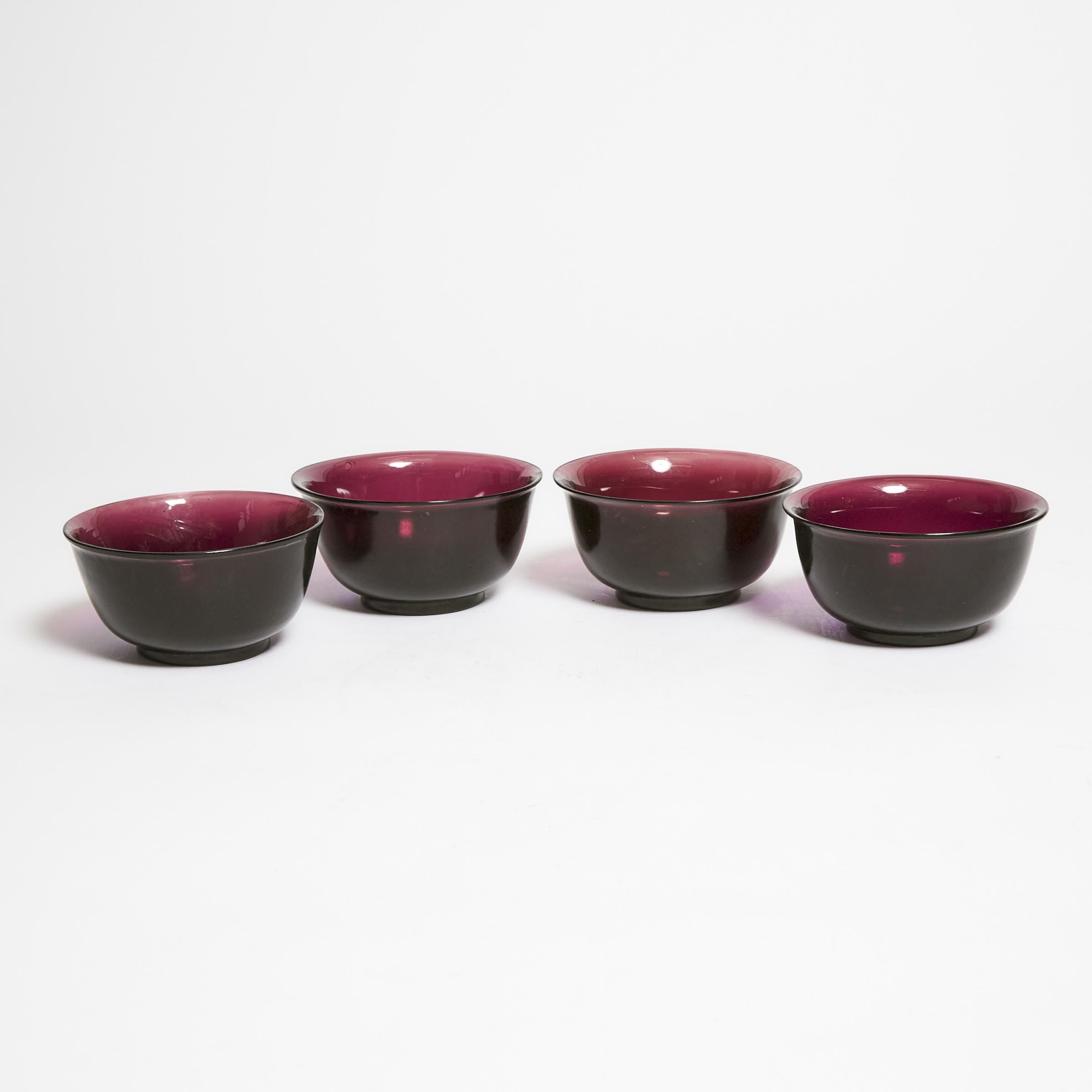 A Set of Four Aubergine Peking Glass Bowls, Early 20th Century