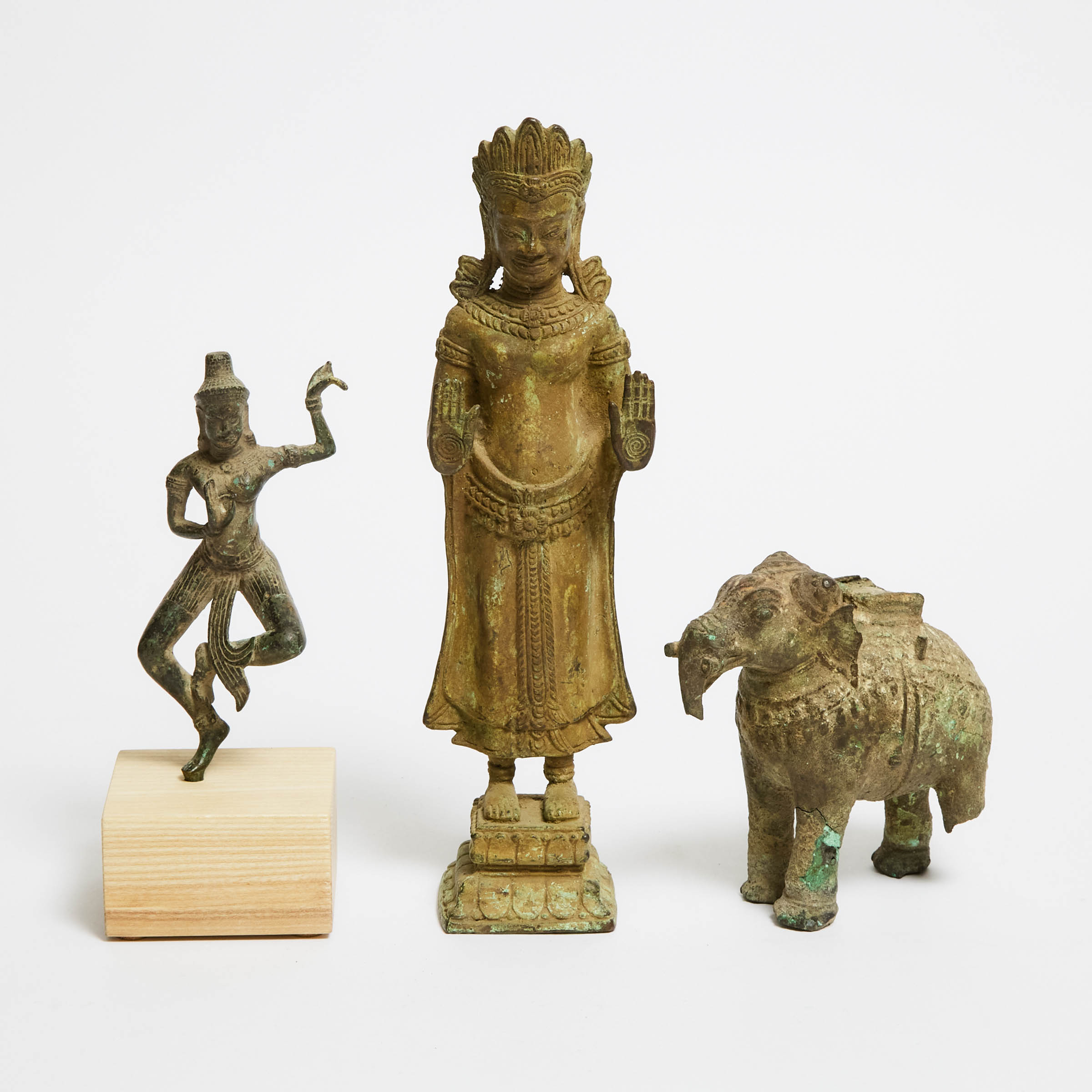 A Group of Three Khmer Bronze Goddesses and Elephant, 12th Century or Later