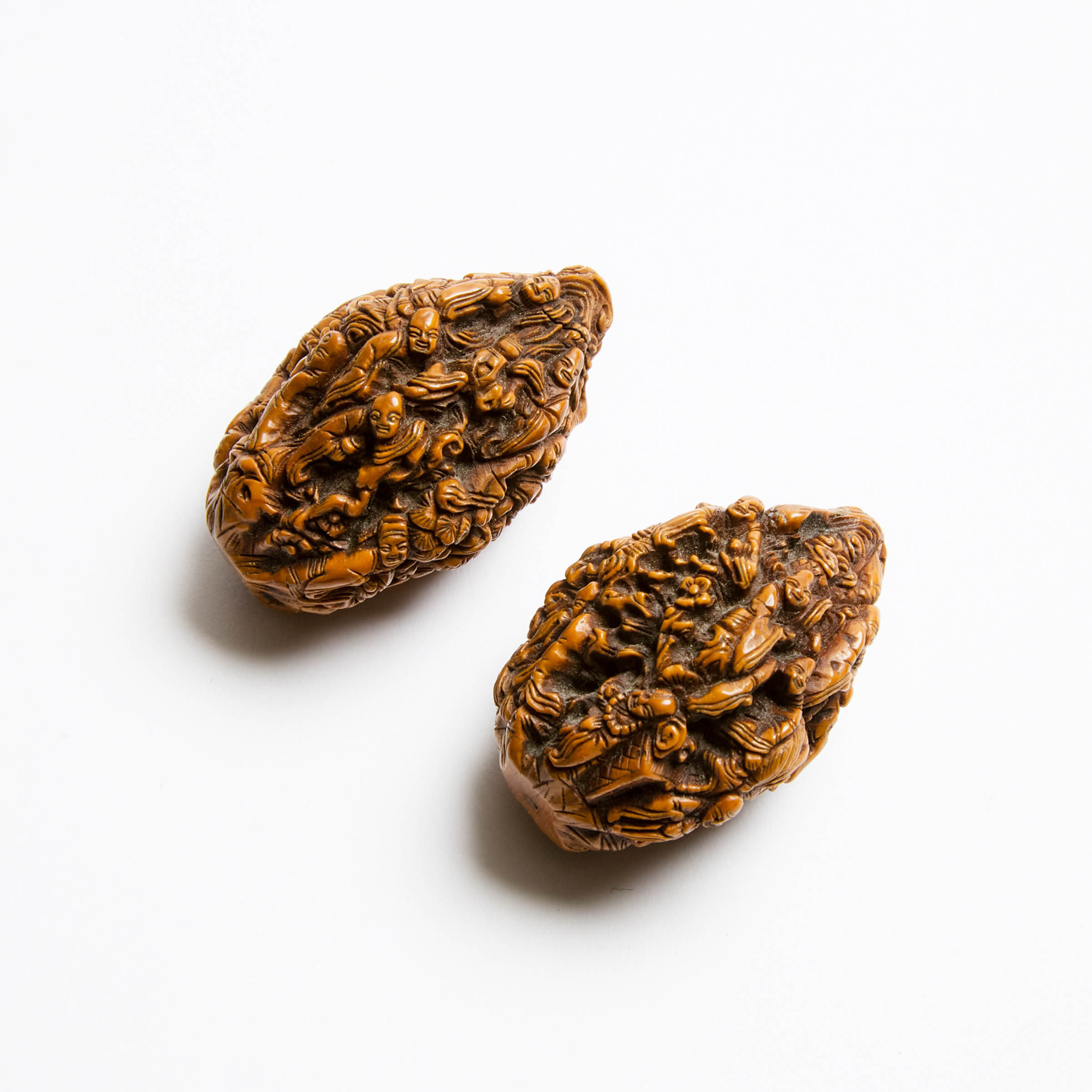 A Pair of Carved 'Eighteen Luohan' Walnuts, Qing Dynasty