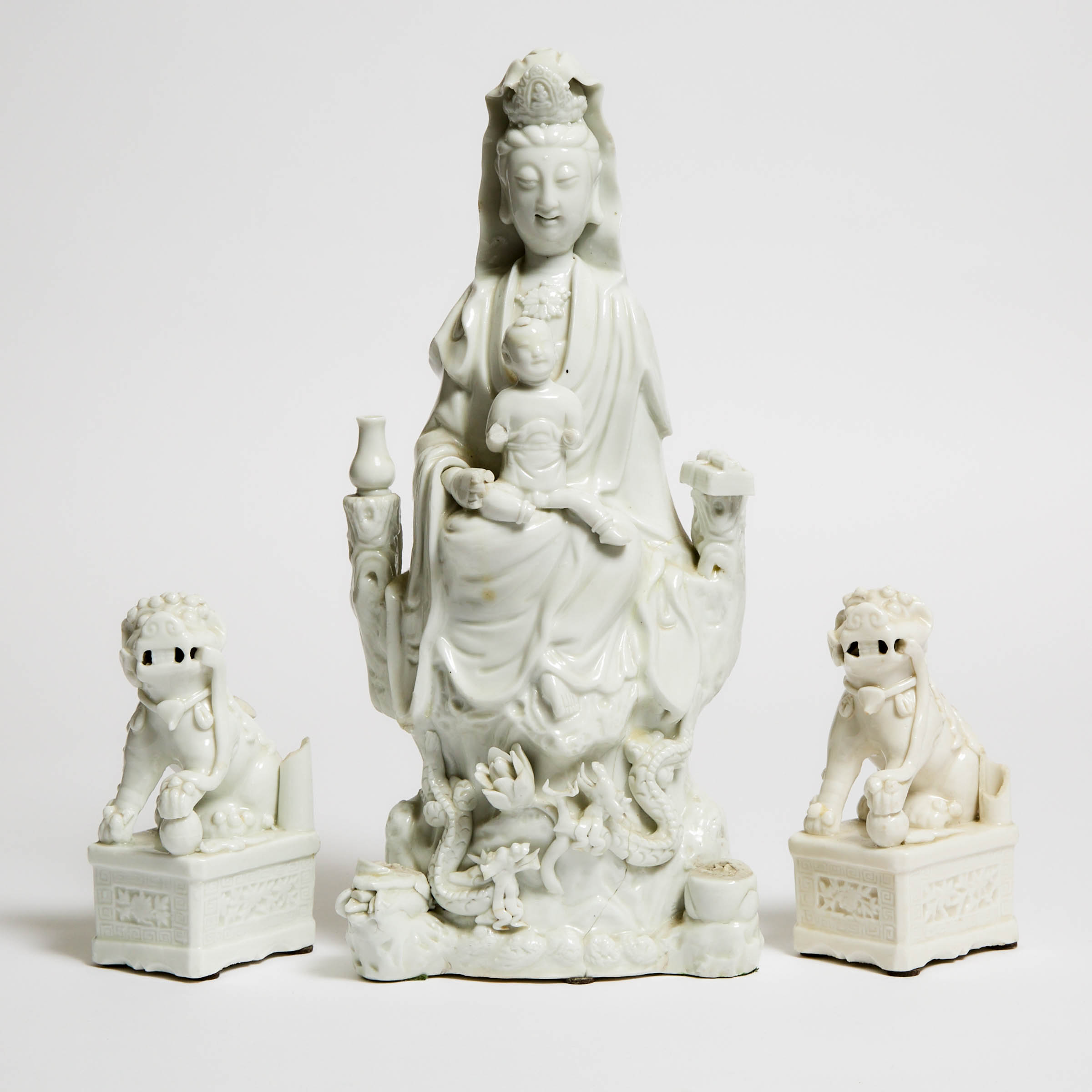 A Pair of Blanc de Chine Lions, Together With a Guanyin Group, Kangxi Period (1662-1722)