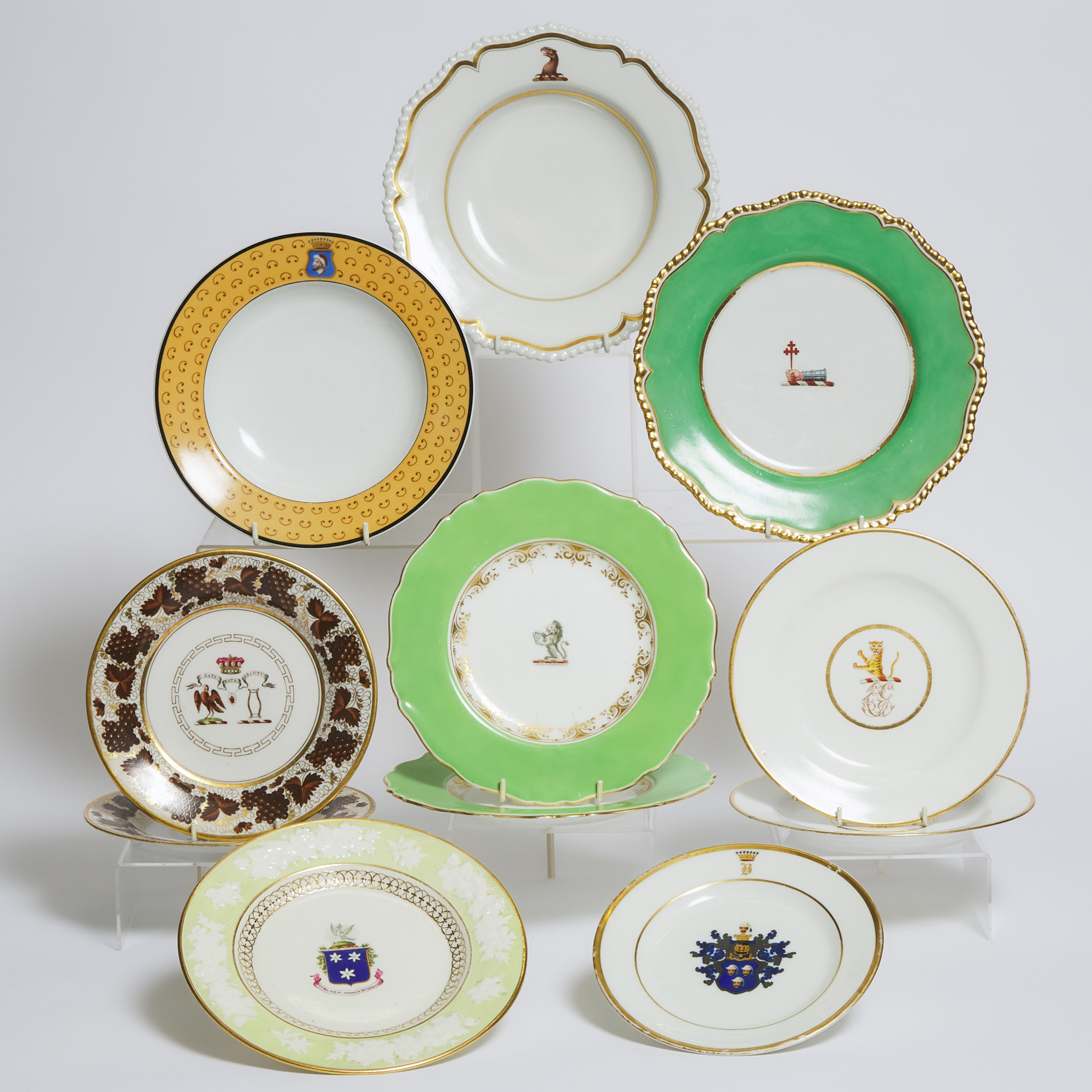 Eleven Various English and Continental Porcelain Armorial or Crest Decorated Plates, 19th century