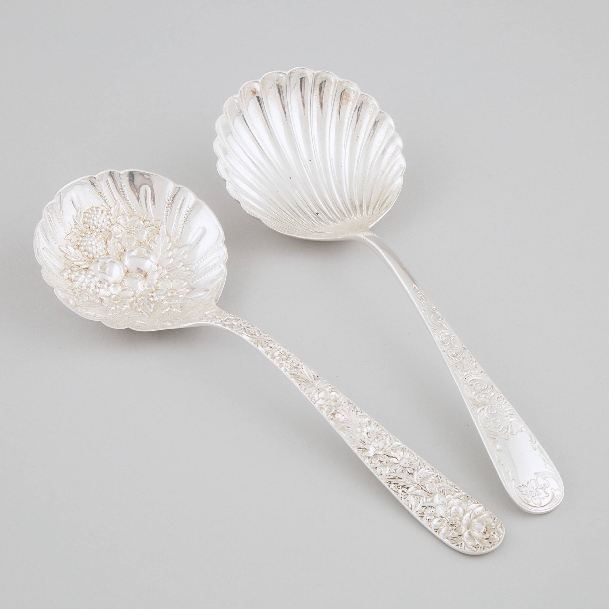 Two American Silver 'Repoussé' and Shell Form Serving Spoons, Samuel Kirk & Son, Baltimore, Md., early 20th century