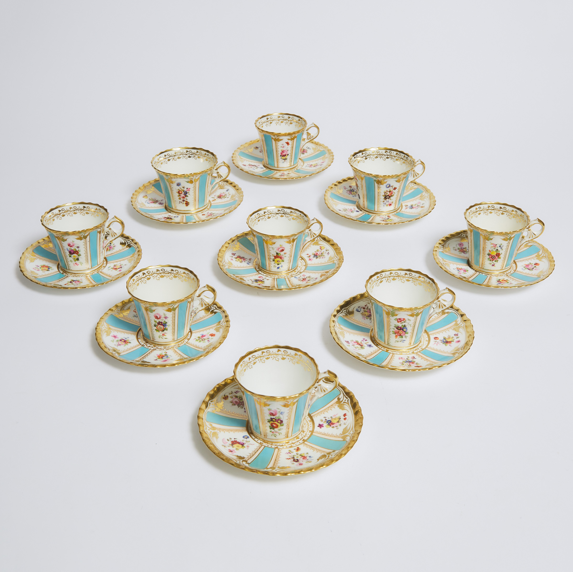 Nine English Porcelain Floral Paneled Blue and Gilt Cups and Saucers, 19th century