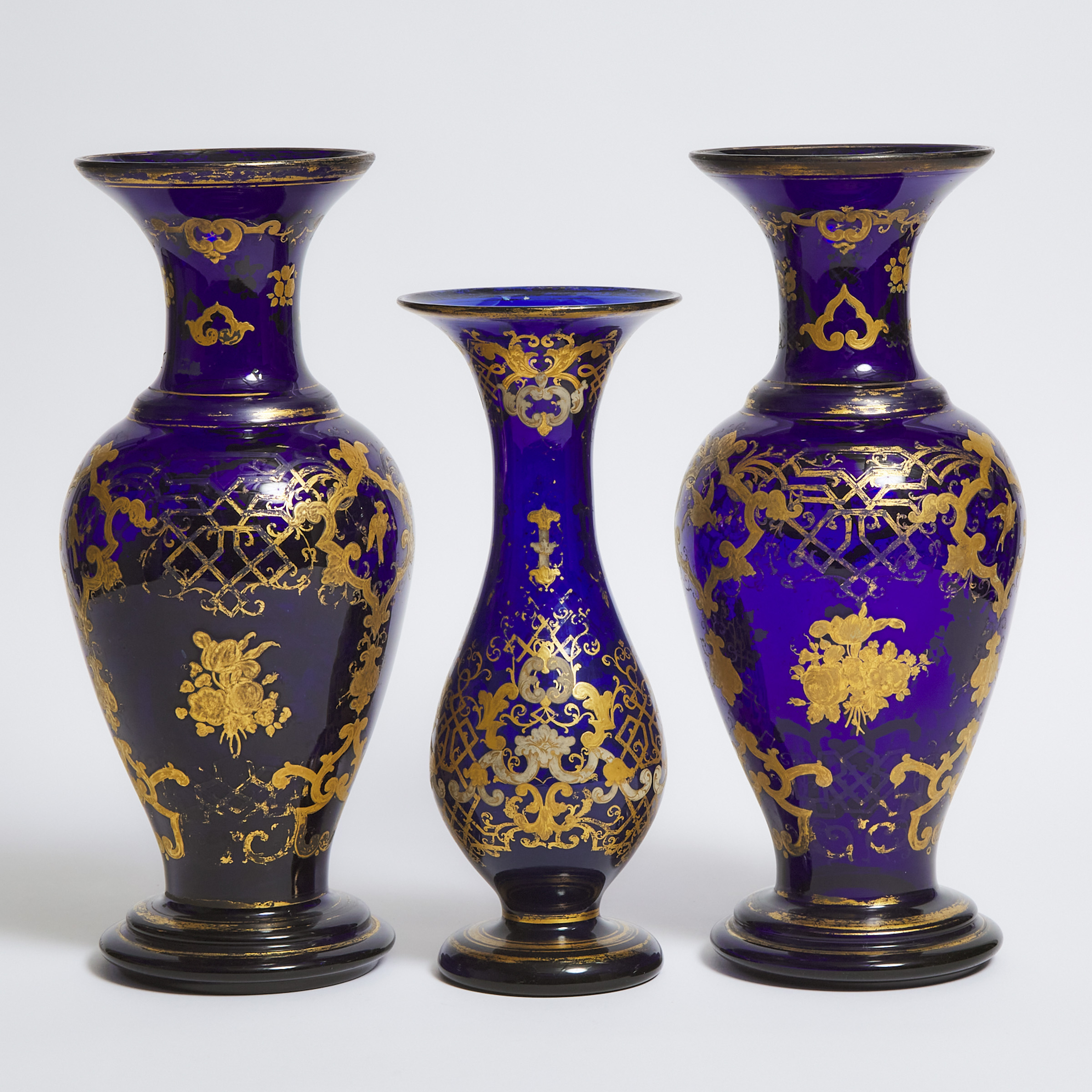 Garniture of Three Continental Gilt Decorated Blue Glass Vases, 19th century