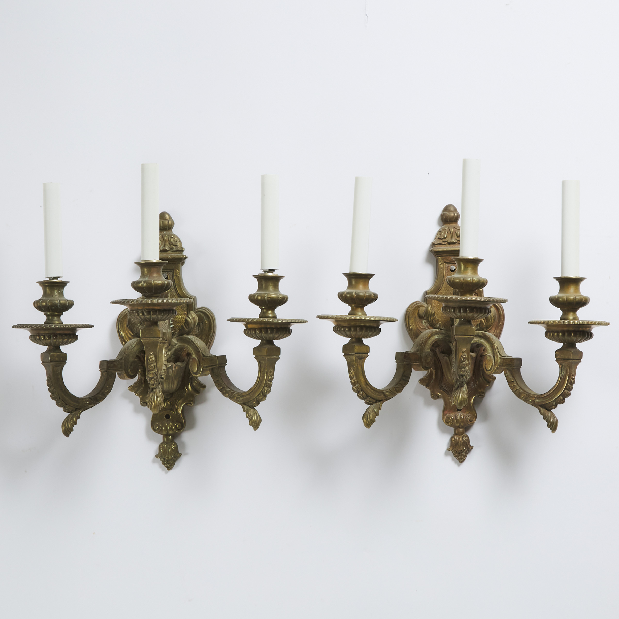 Pair of French 18th Century Style Three Light Gilt Bronze Wall Sconces, early 20th century