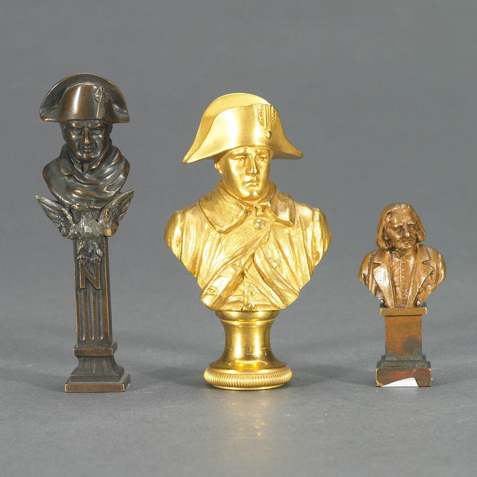 Two French Patinated Bronze Bust Form Desk Seals, Napoleon and Voltaire, late 19th century together with a later Gilt Bronze Bust of Form Seal of Napoleon